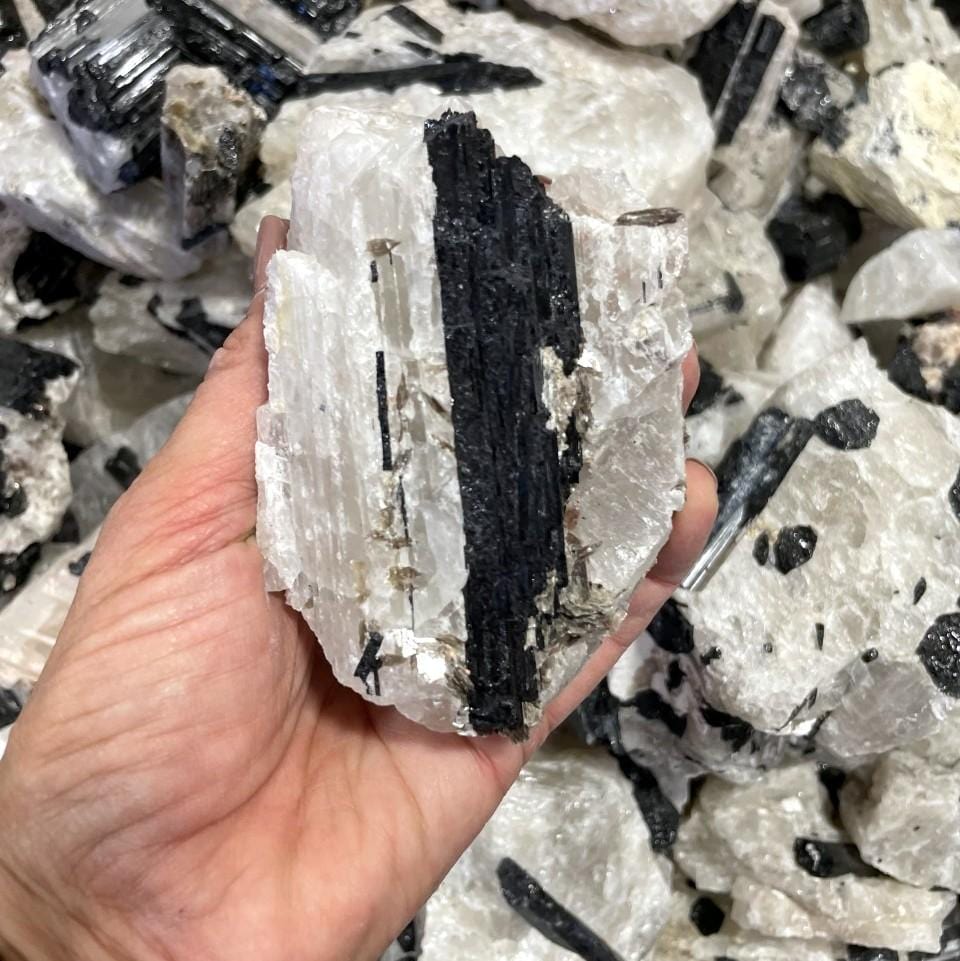 chunk of tourmaline in hand to show detail textures and inclusions