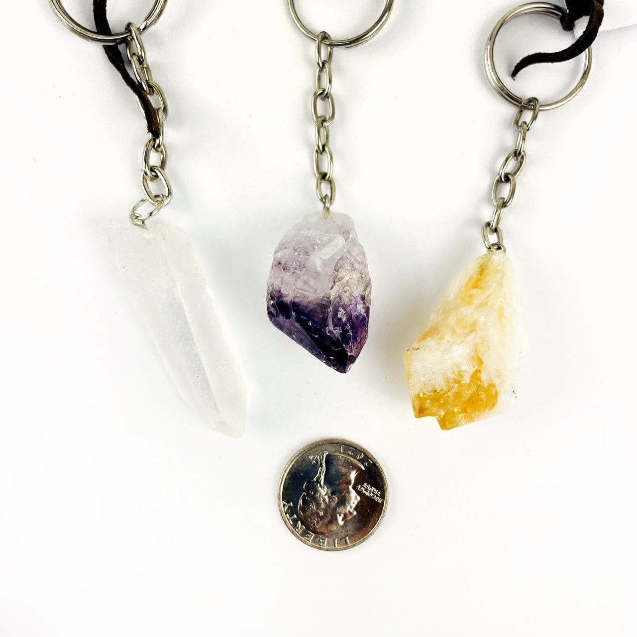 One of each: crystal Quartz Point, Citrine Point and Amethyst Point, around a quarter for size reference