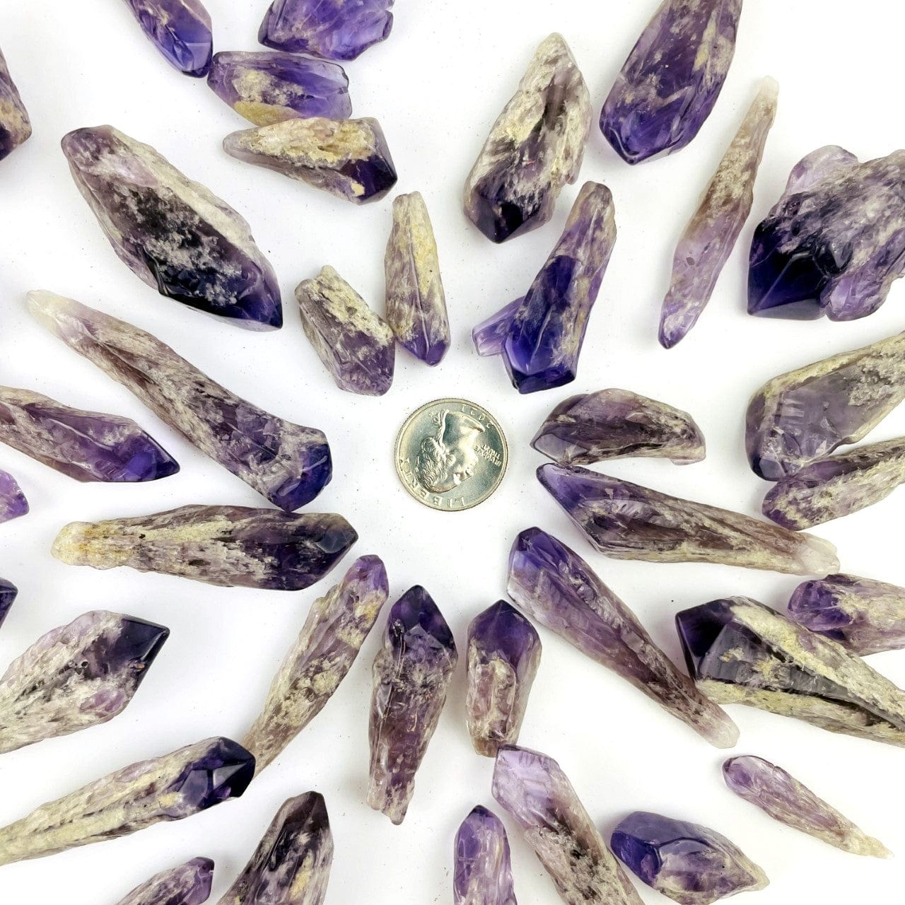 Elestial Amethyst Point - 1 Pound Bag spread around a quarter for size reference