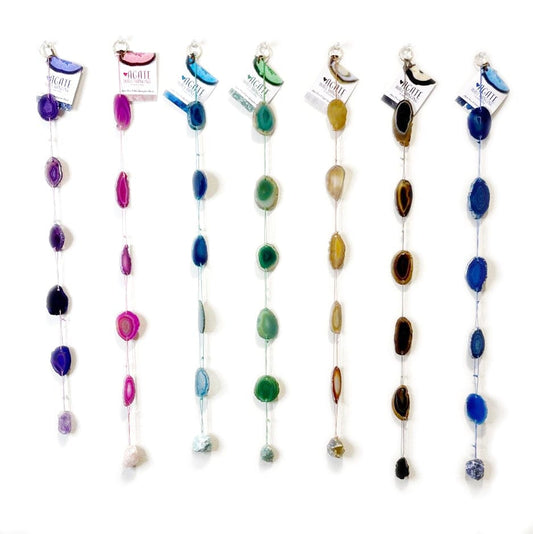 Dyed Agate wall hanging made up of Agate slices strung on complimentary colored cording, finished off with the same color of stone!