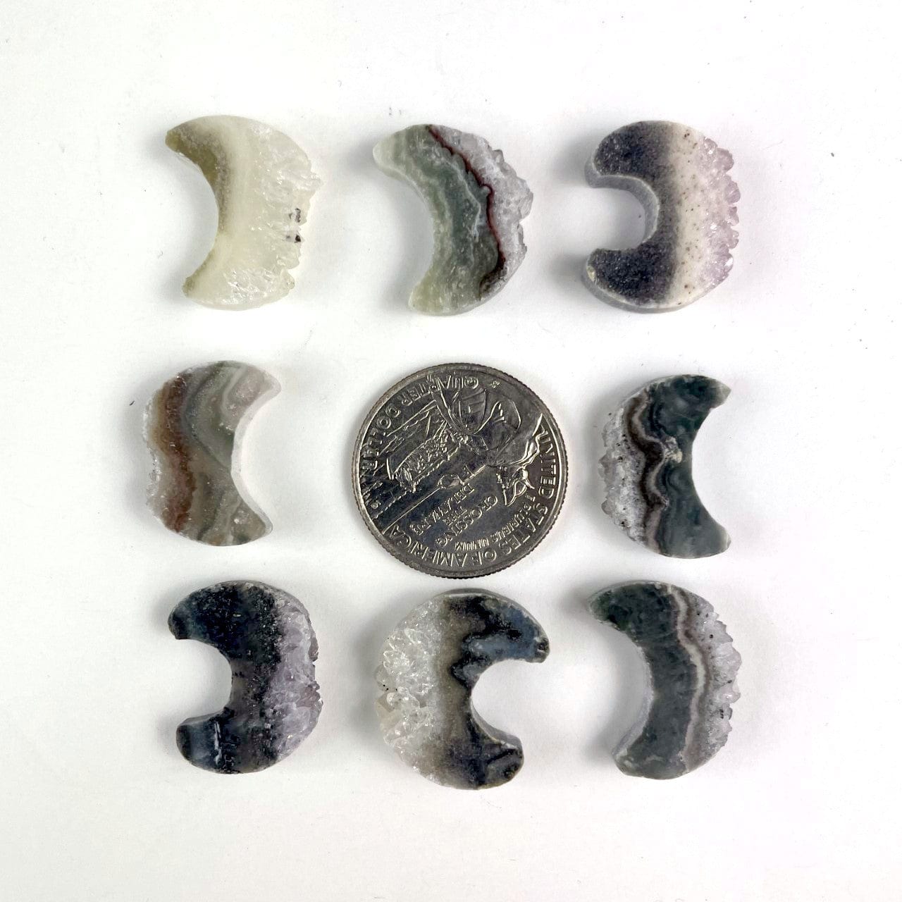 amethyst moon crescents surrounding a quarter for size reference