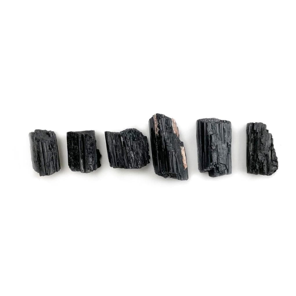 multiple black tourmaline pendant sized rods displaying different sizes and textures