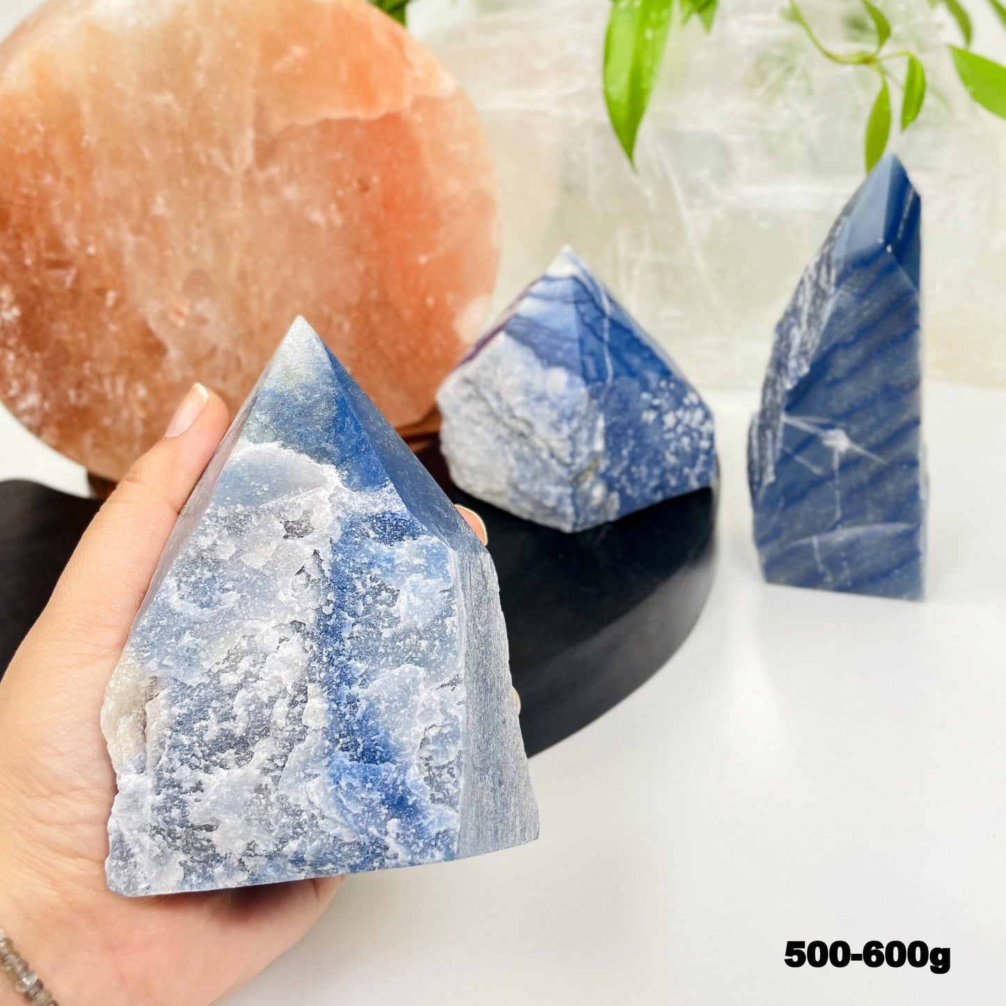 blue quartz point in hand for size reference 