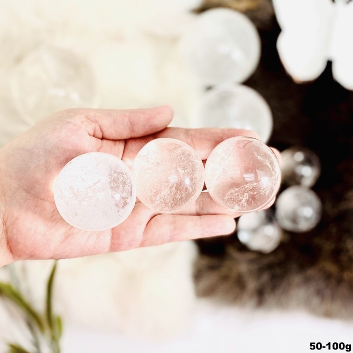 50-100g spheres displayed in hand for size reference