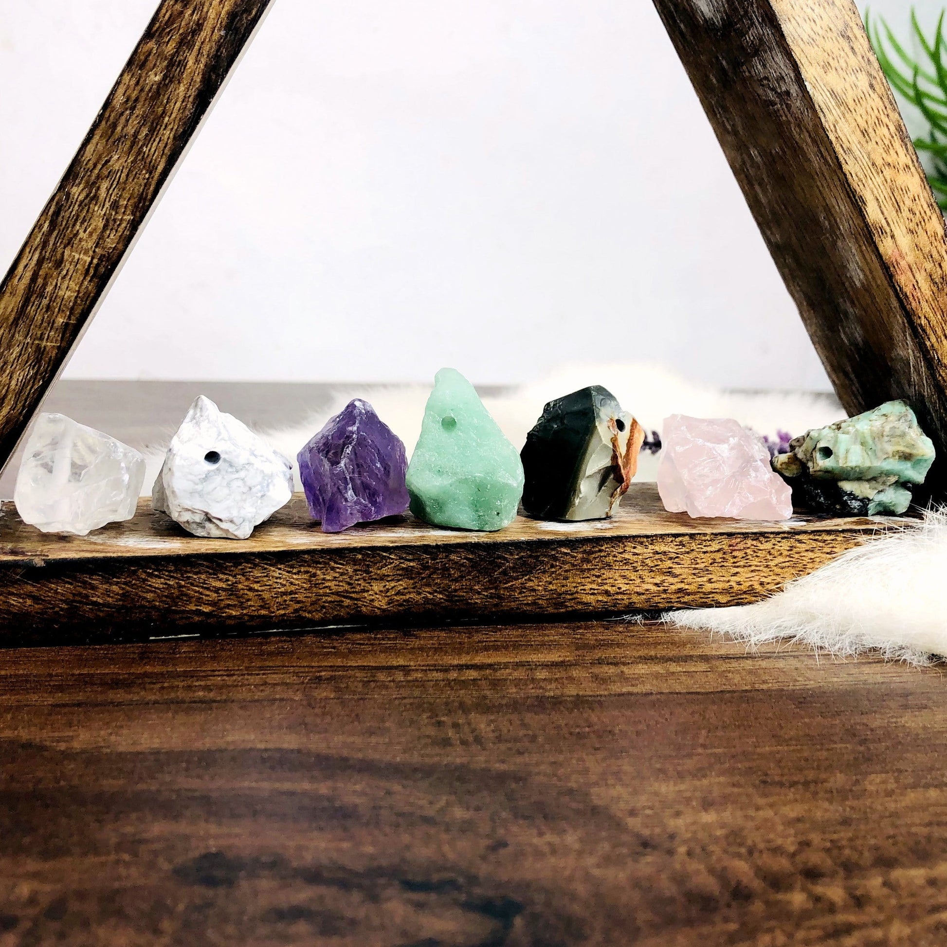 Rough Stone Beads lined up on bottom of triangular display