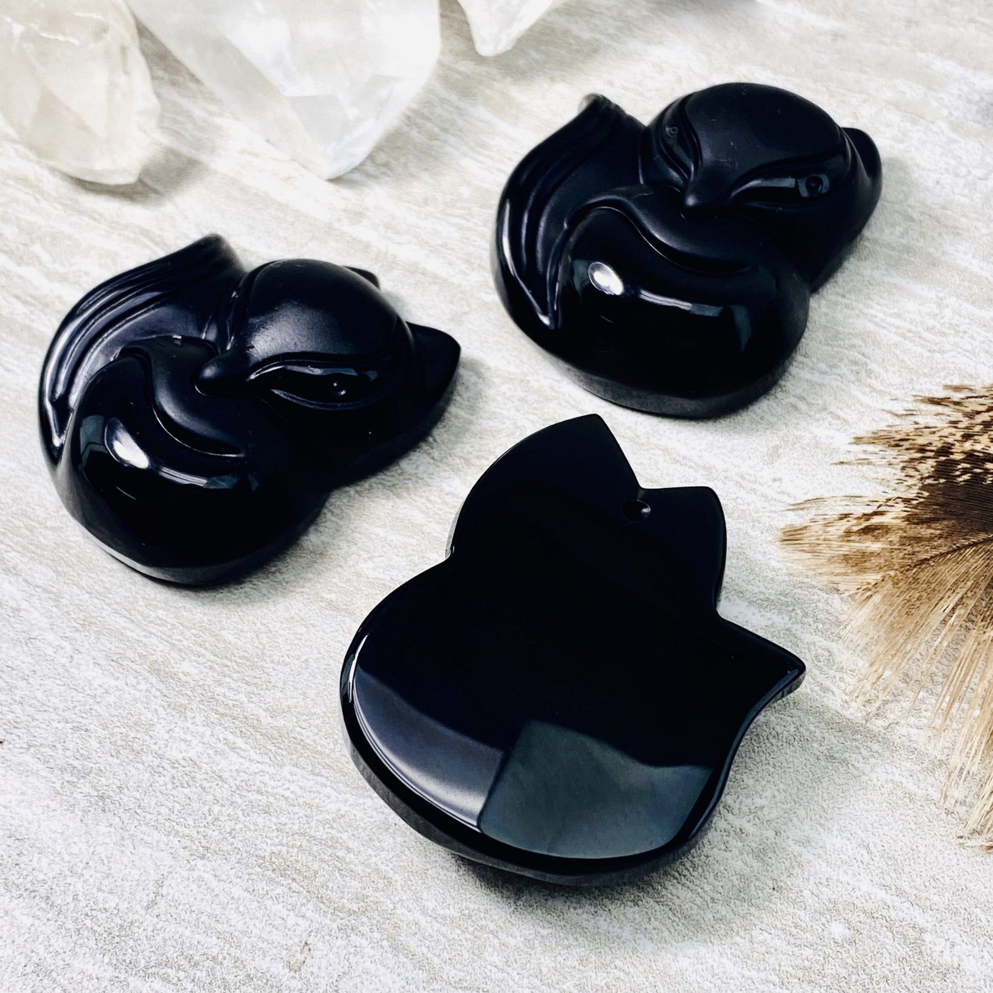 3 black onyx fox beads with one showing the back