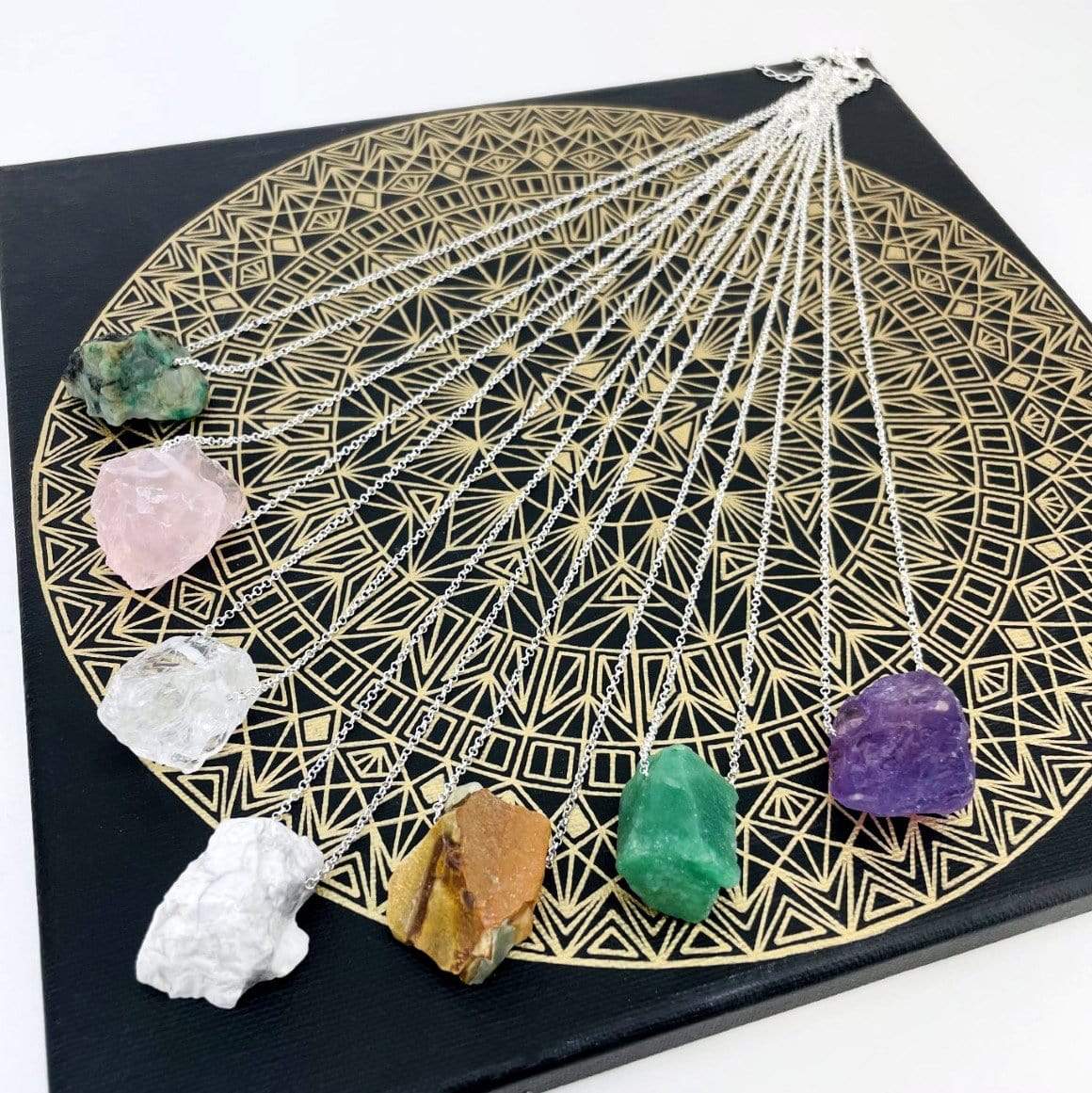 Healing Stone Necklaces with silver chain on crystal grid