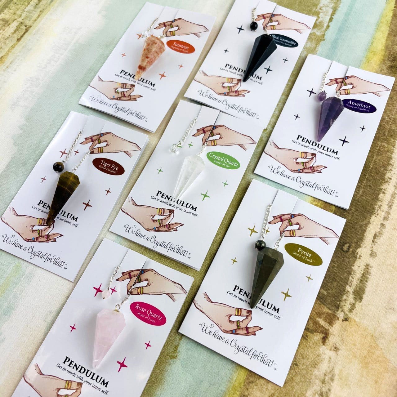 various crystal pendulums on information cards