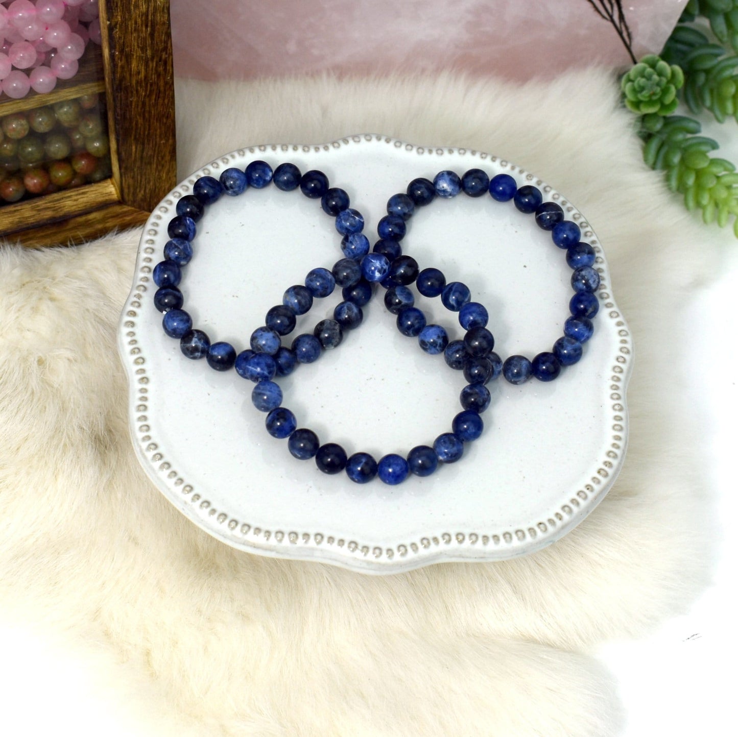 overhead view of three sodalite round bead bracelets for possible variations