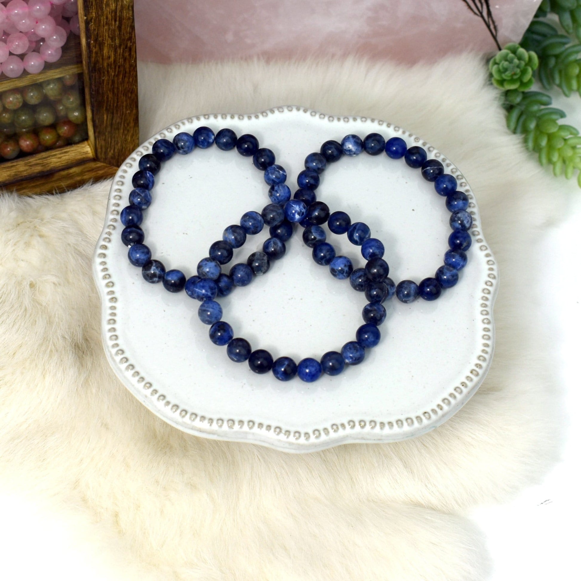 overhead view of three sodalite round bead bracelets for possible variations