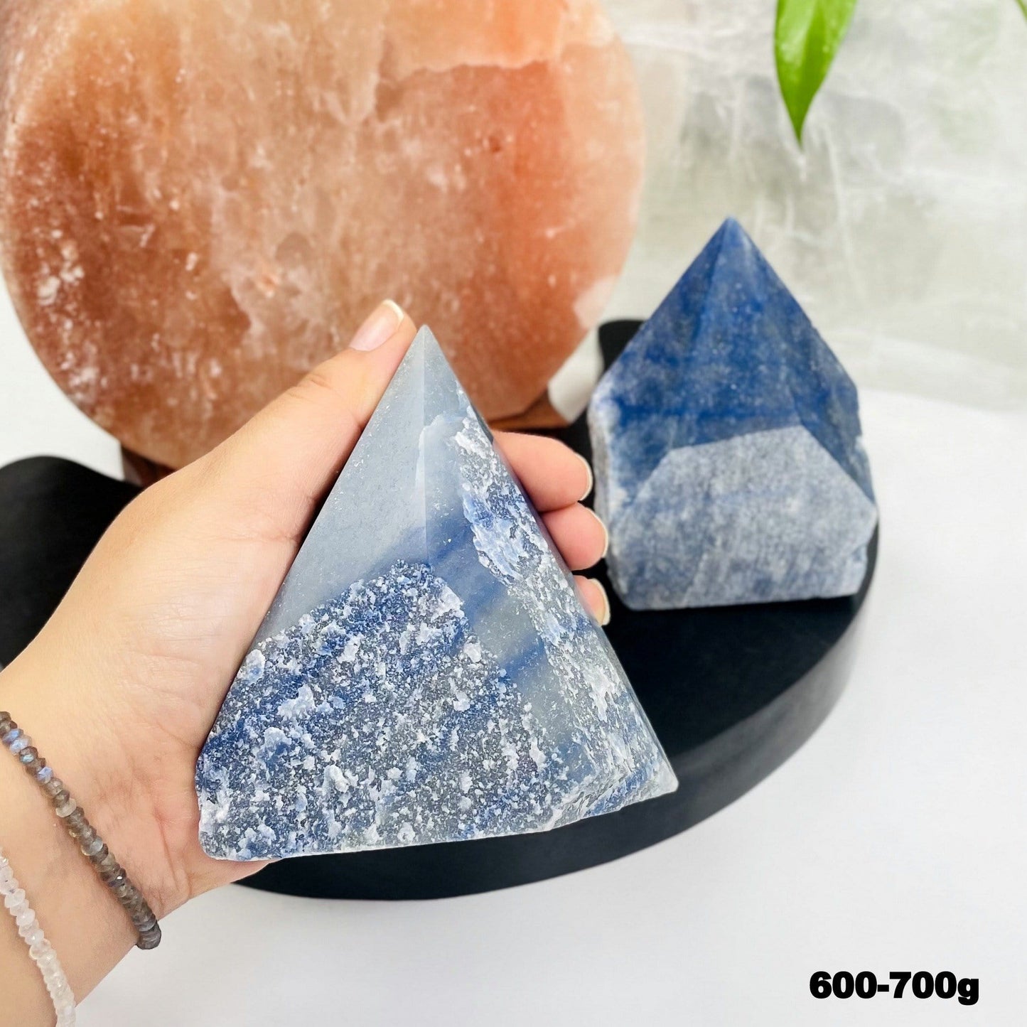 blue quartz point in hand for size reference 