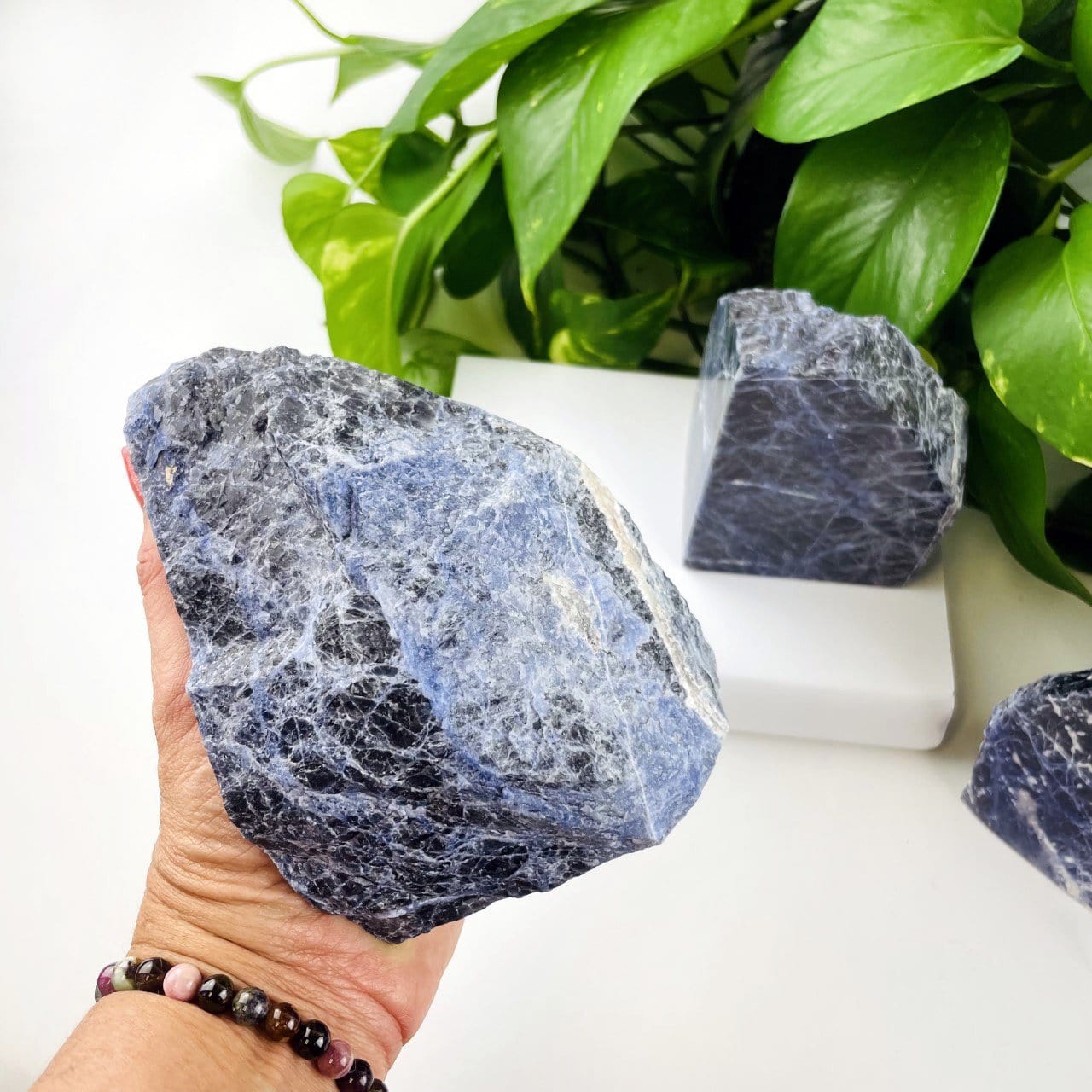 Back of bookend in hand for size reference and to show rough edge and back of stone