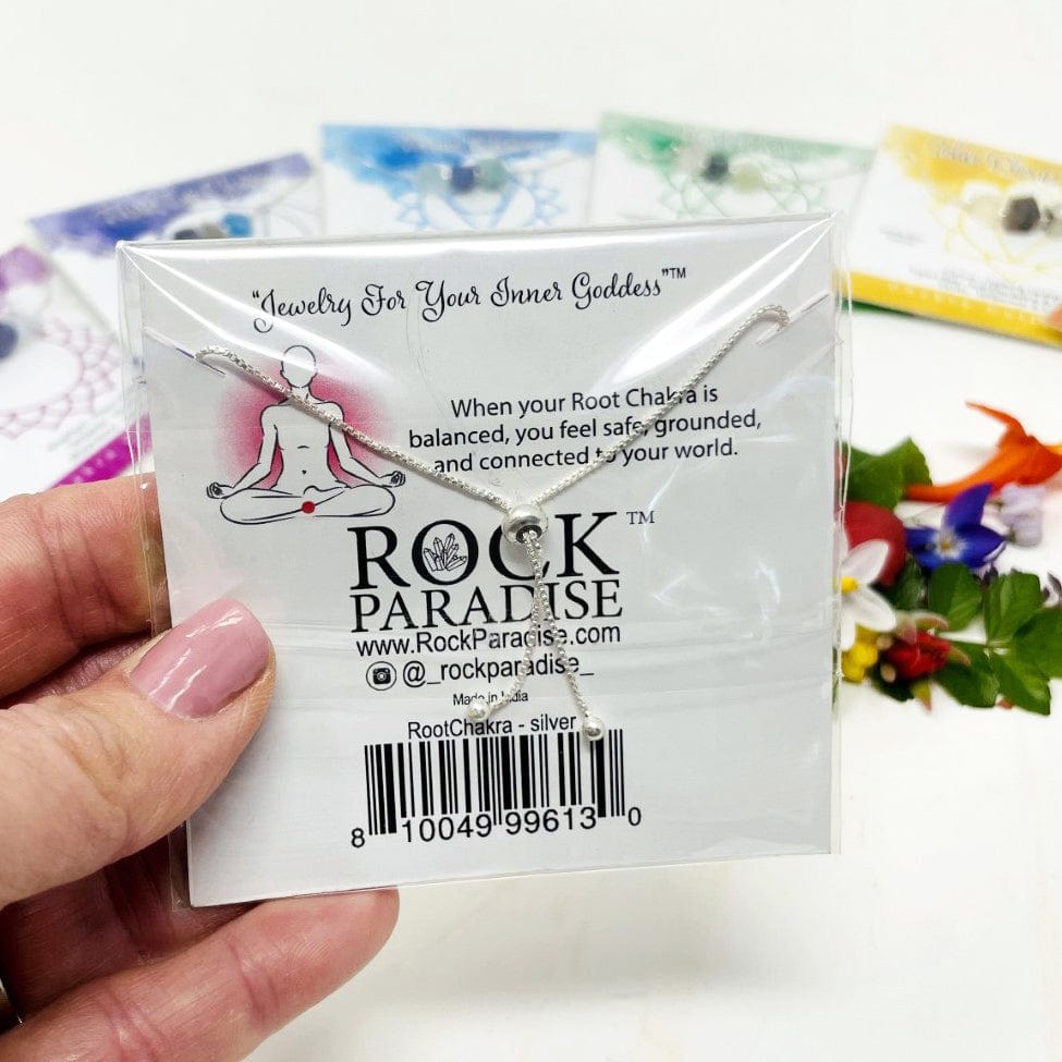 close up of the back of the chakra packaging and the back of the adjustable bracelet 