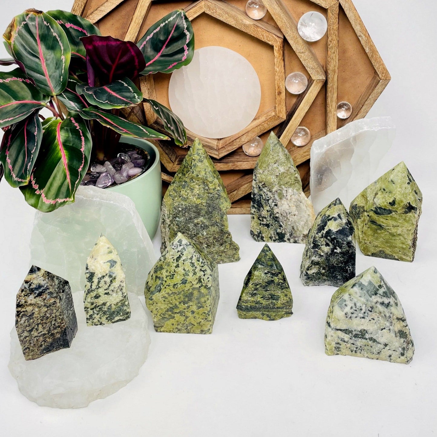 Nine, various-sized Jadeite Semi-polished Points displayed on white surface.