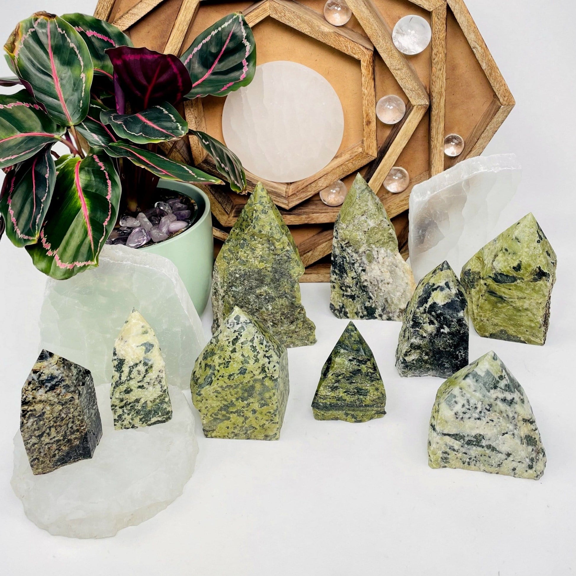 Nine, various-sized Jadeite Semi-polished Points displayed on white surface.