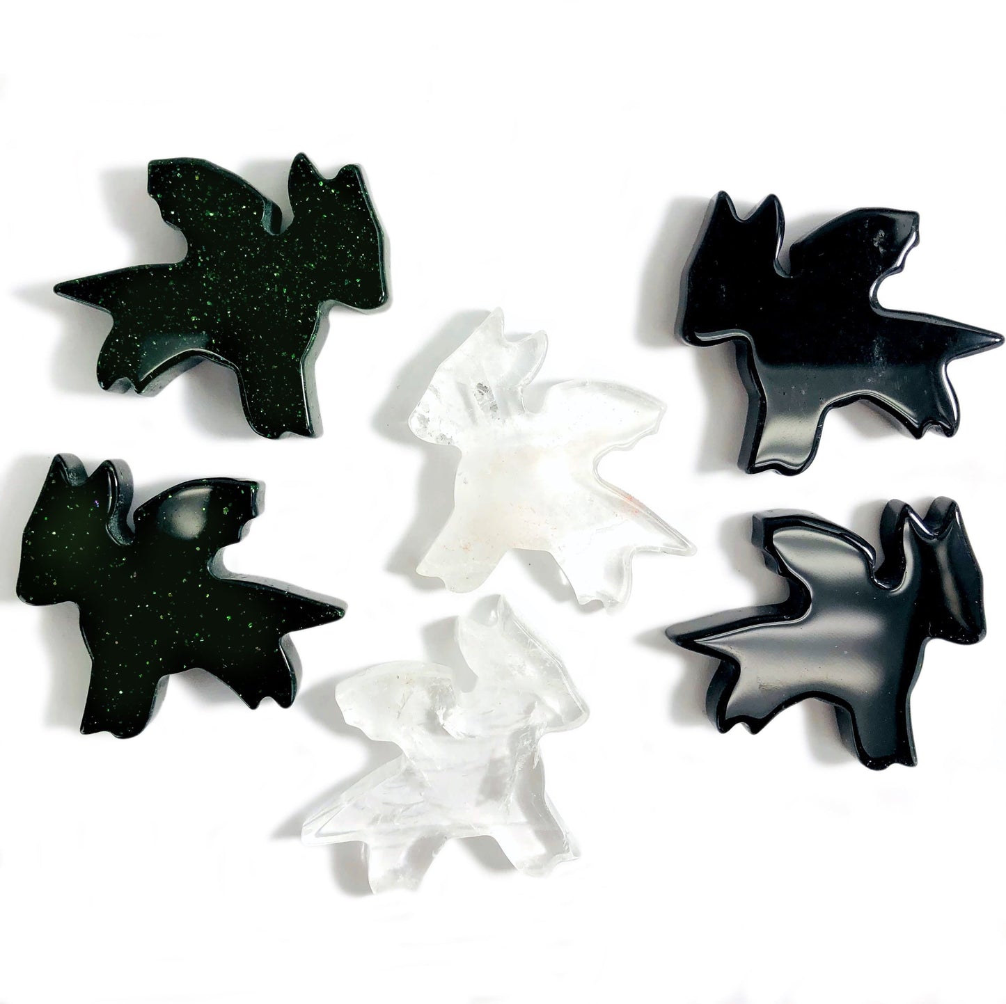 4 green goldstone dragoms 2 crystal quartz dragons displayed to show characteristic variations