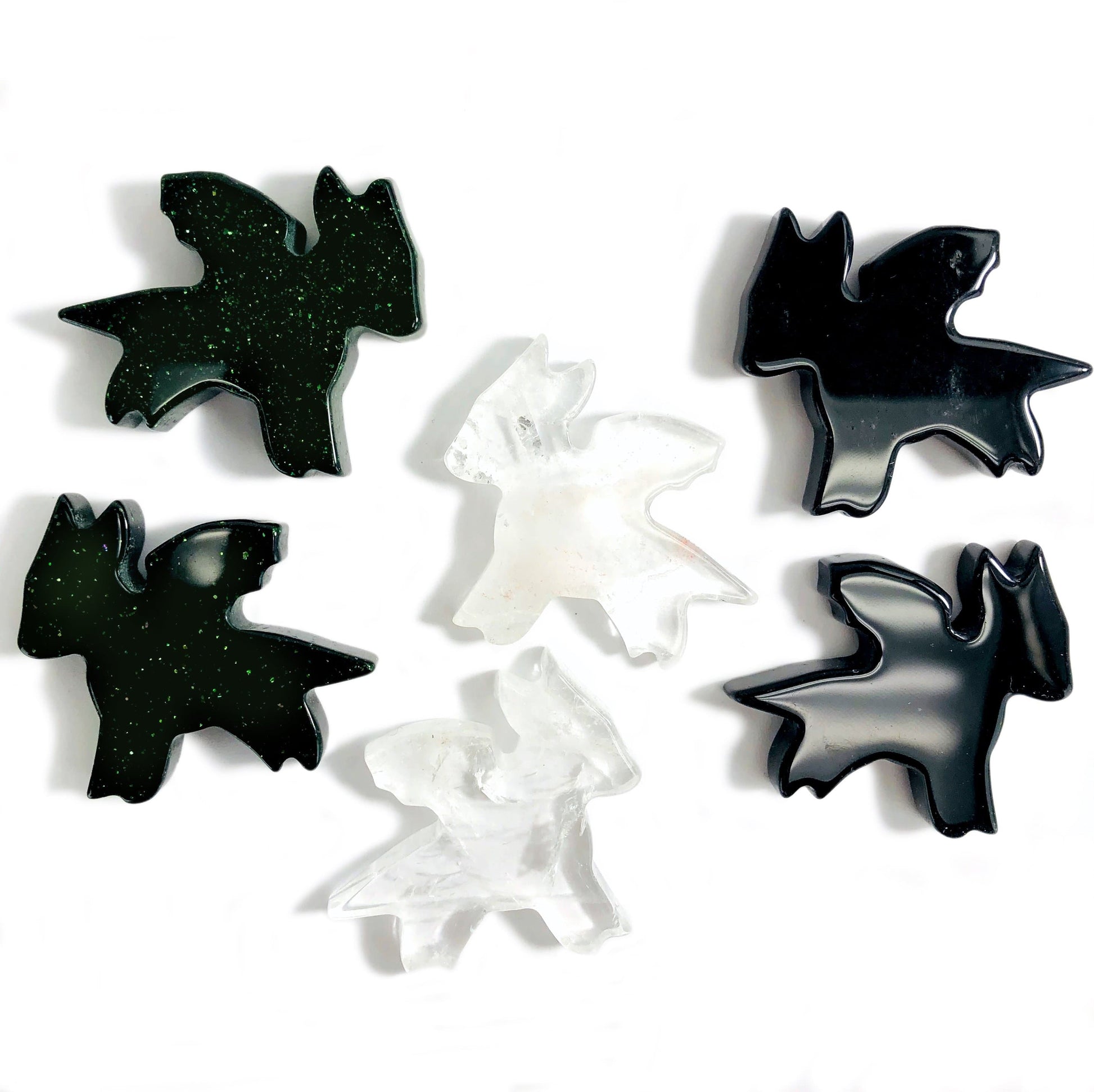 4 green goldstone dragoms 2 crystal quartz dragons displayed to show characteristic variations