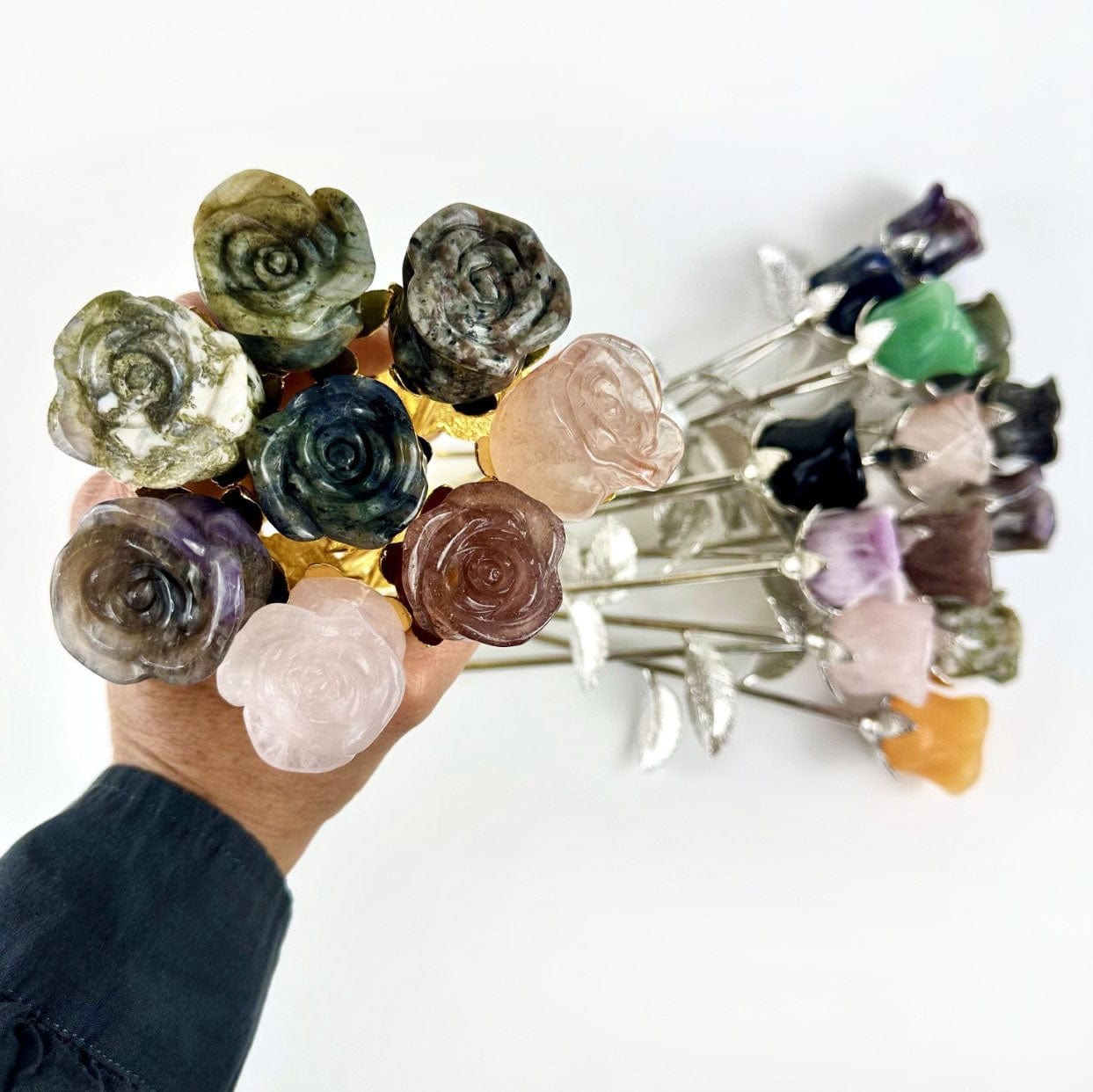Crystal Rose - Carved Stones with some in a hand and others in background