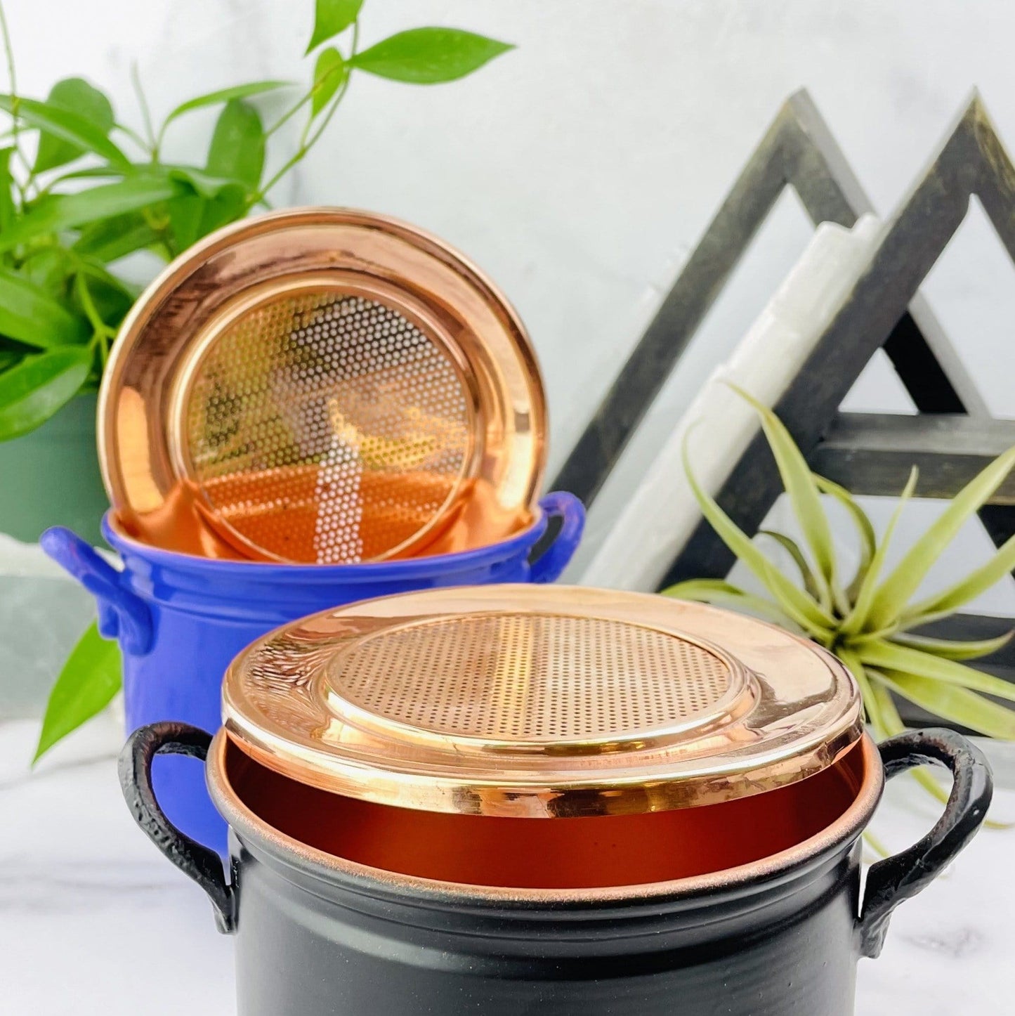 Close uop view of black and purple Metal Cauldron with lid