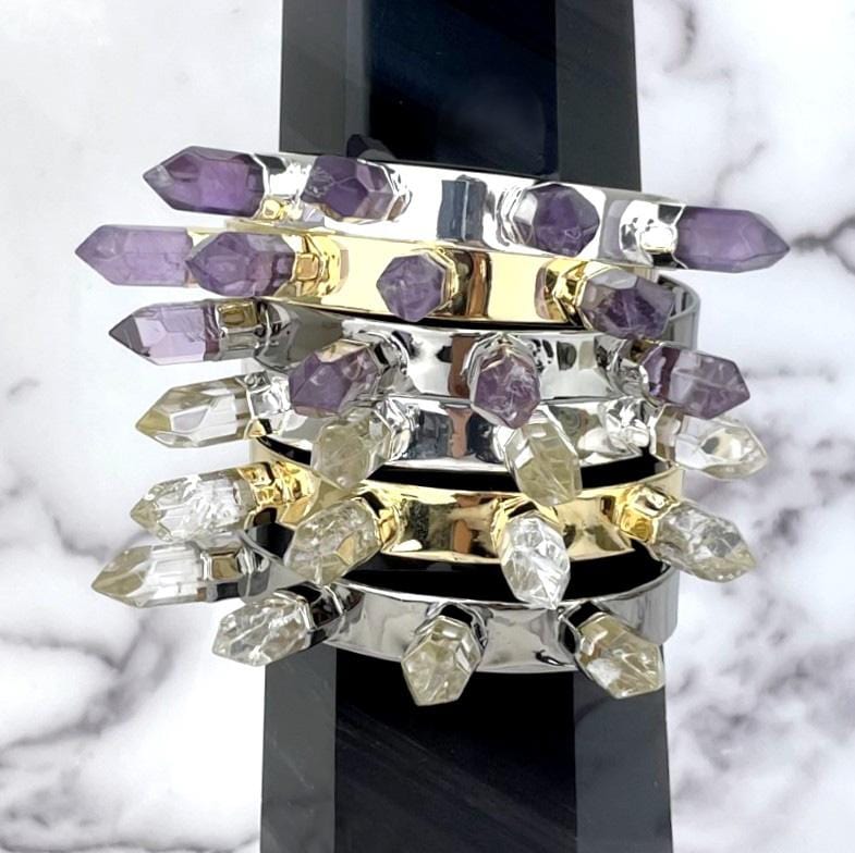 bracelets displayed to on bracelet holder on white background