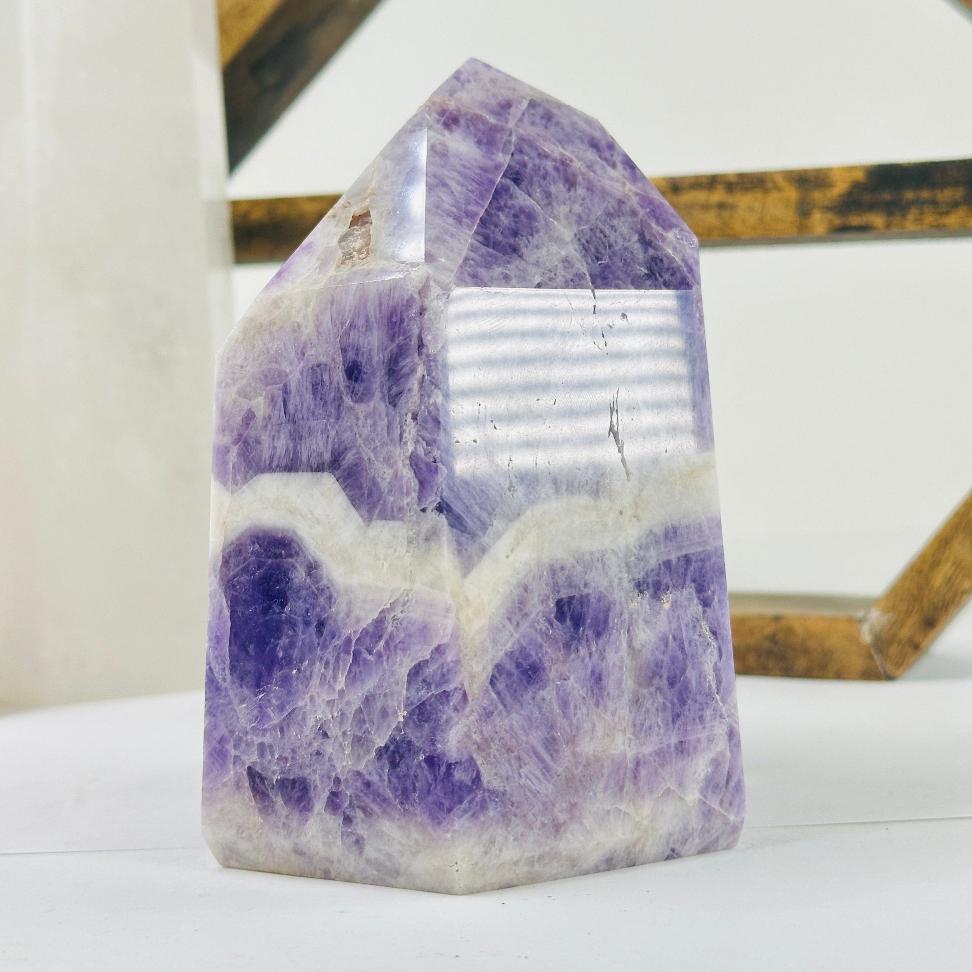 chevron amethyst polished point with decorations in the background