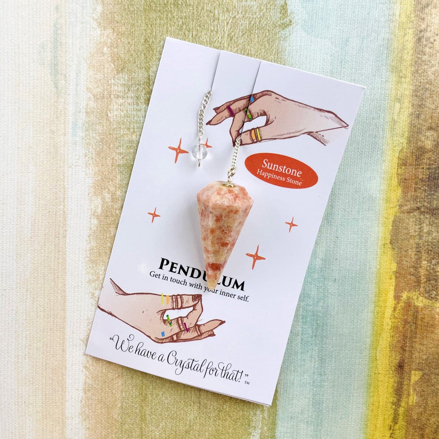 sunstone crystal pendulum on information card