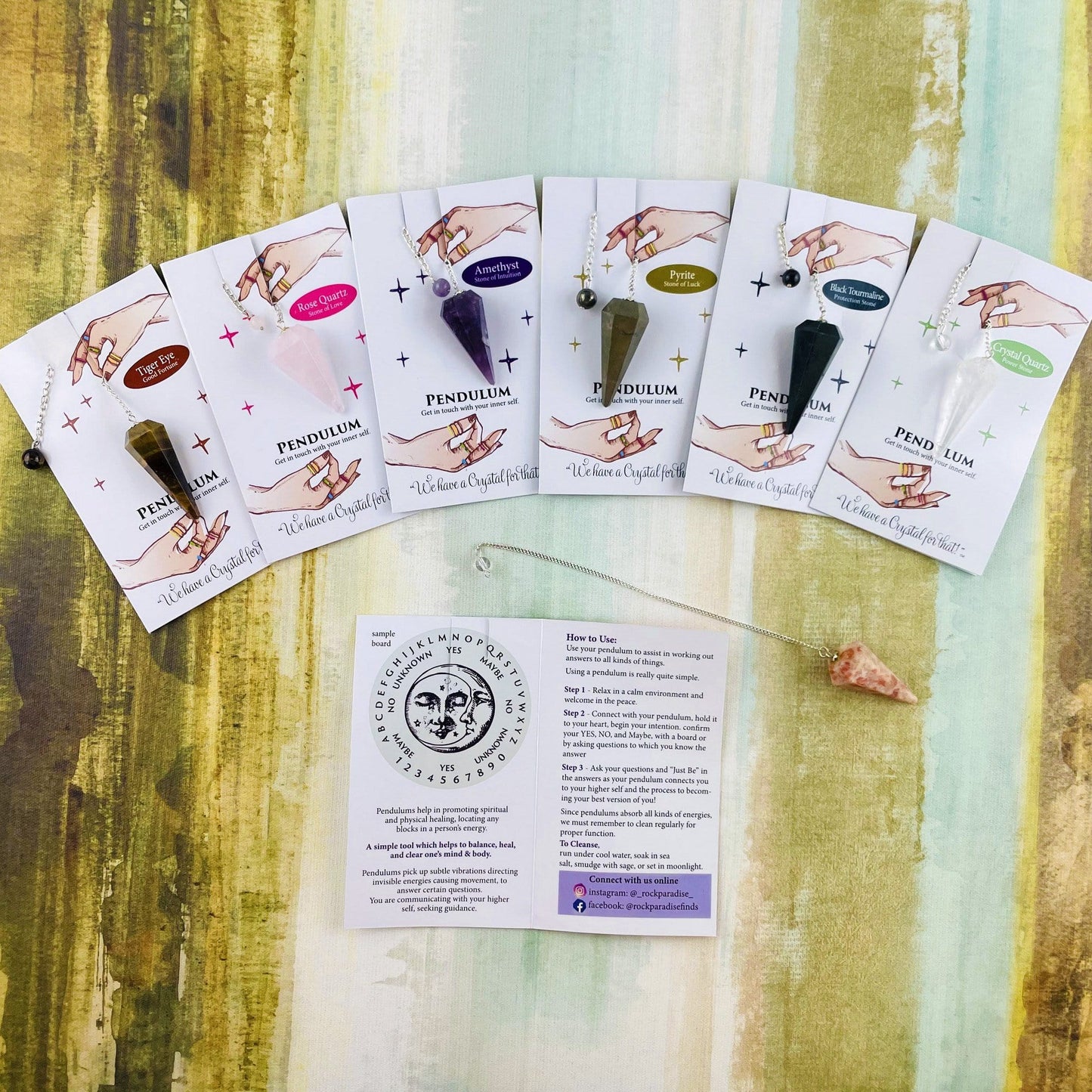 various crystal pendulums on information card
