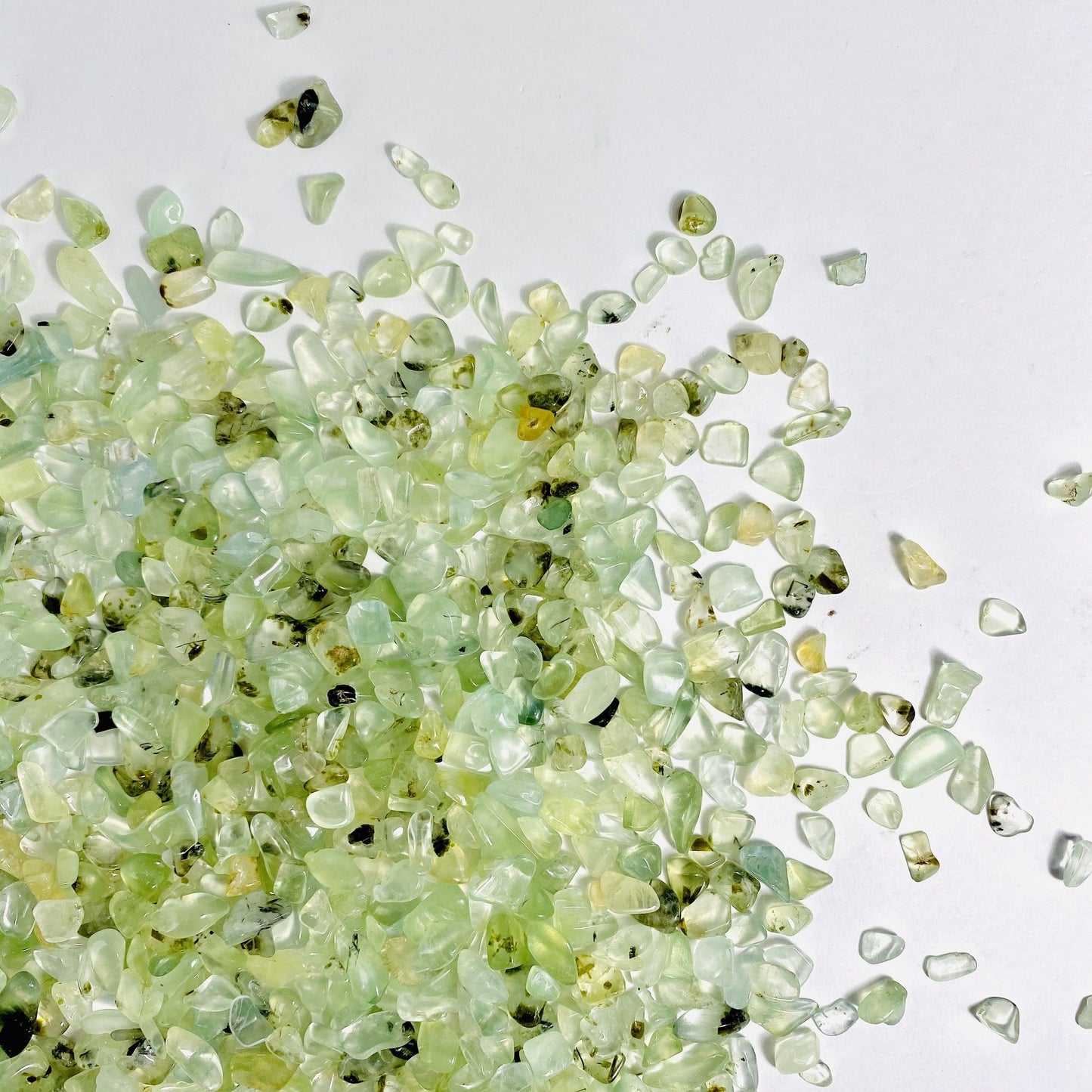 green prehnite chips on a white background