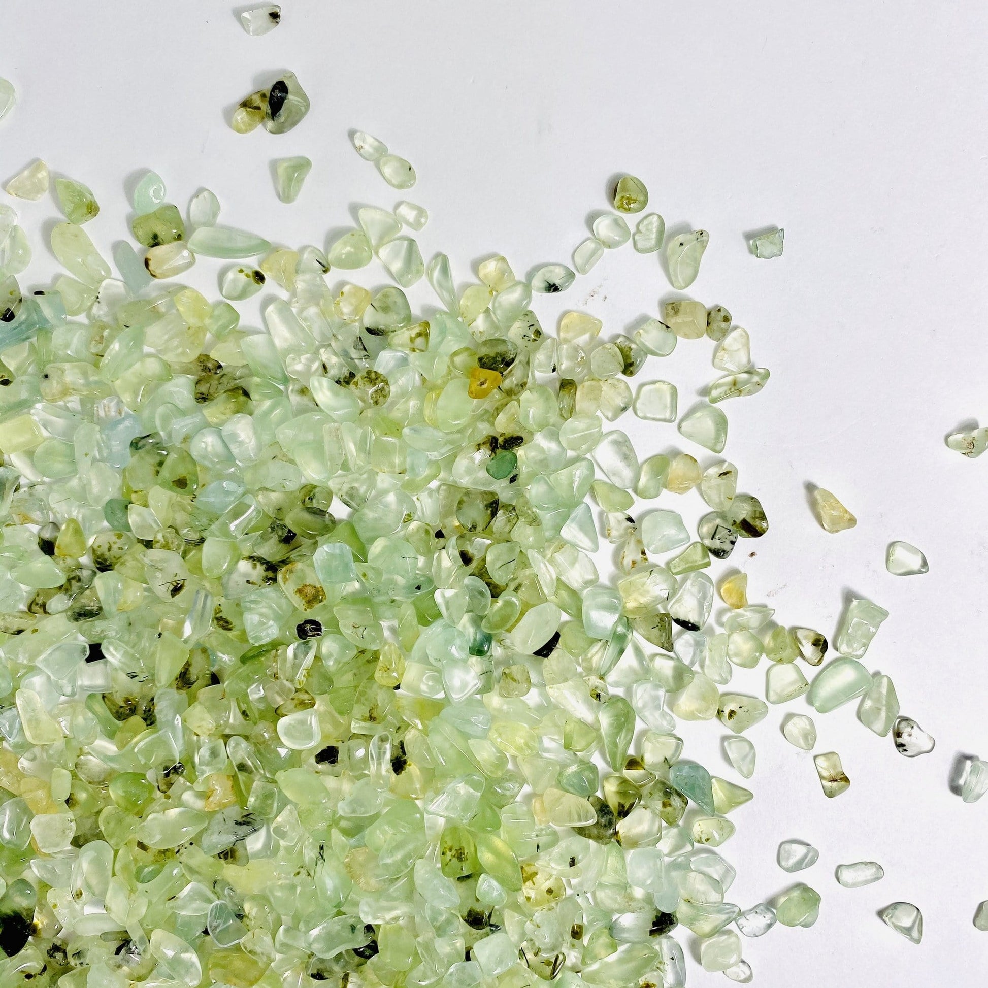 green prehnite chips on a white background