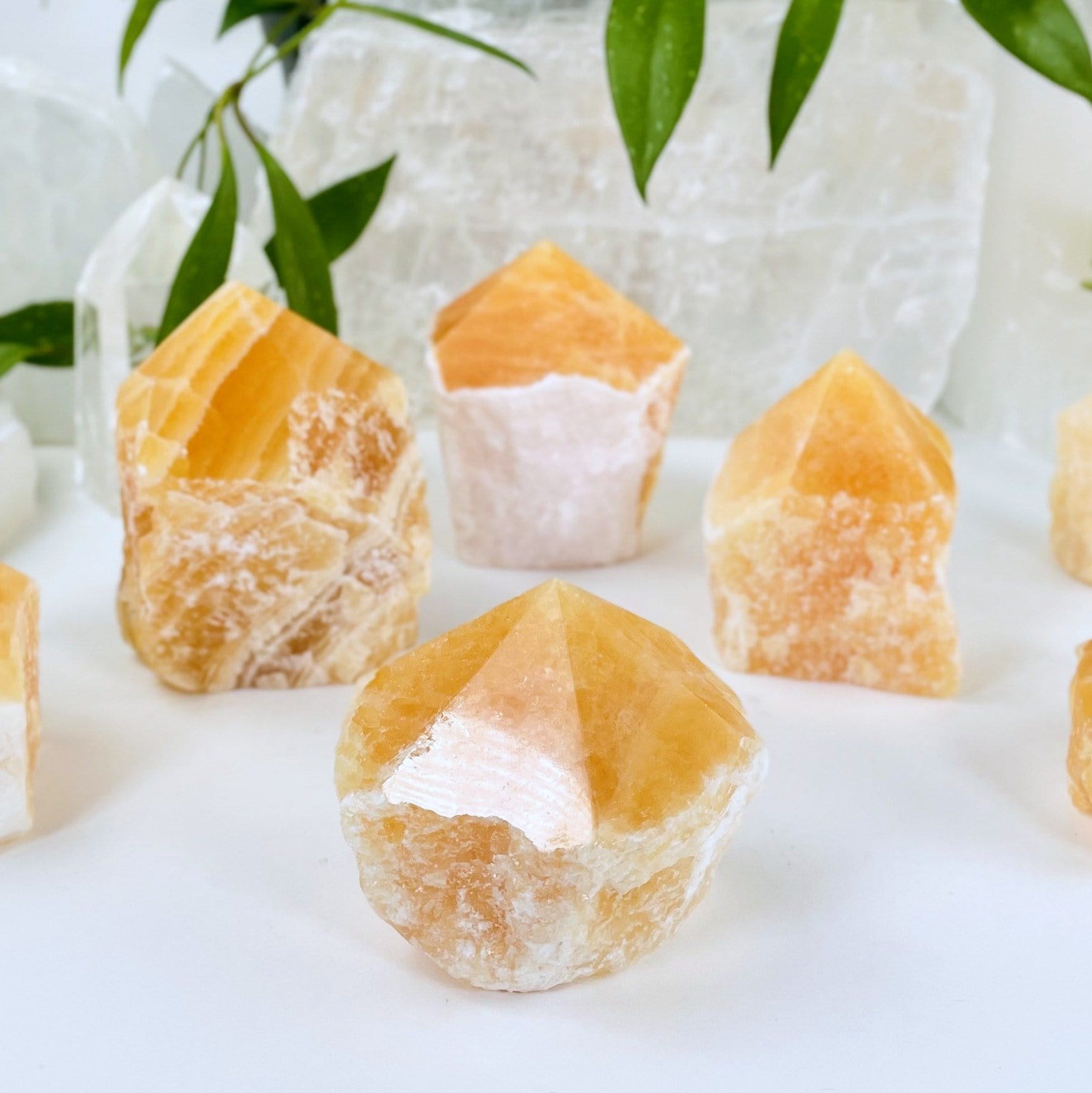 Orange Calcite Point - 4 on a table
