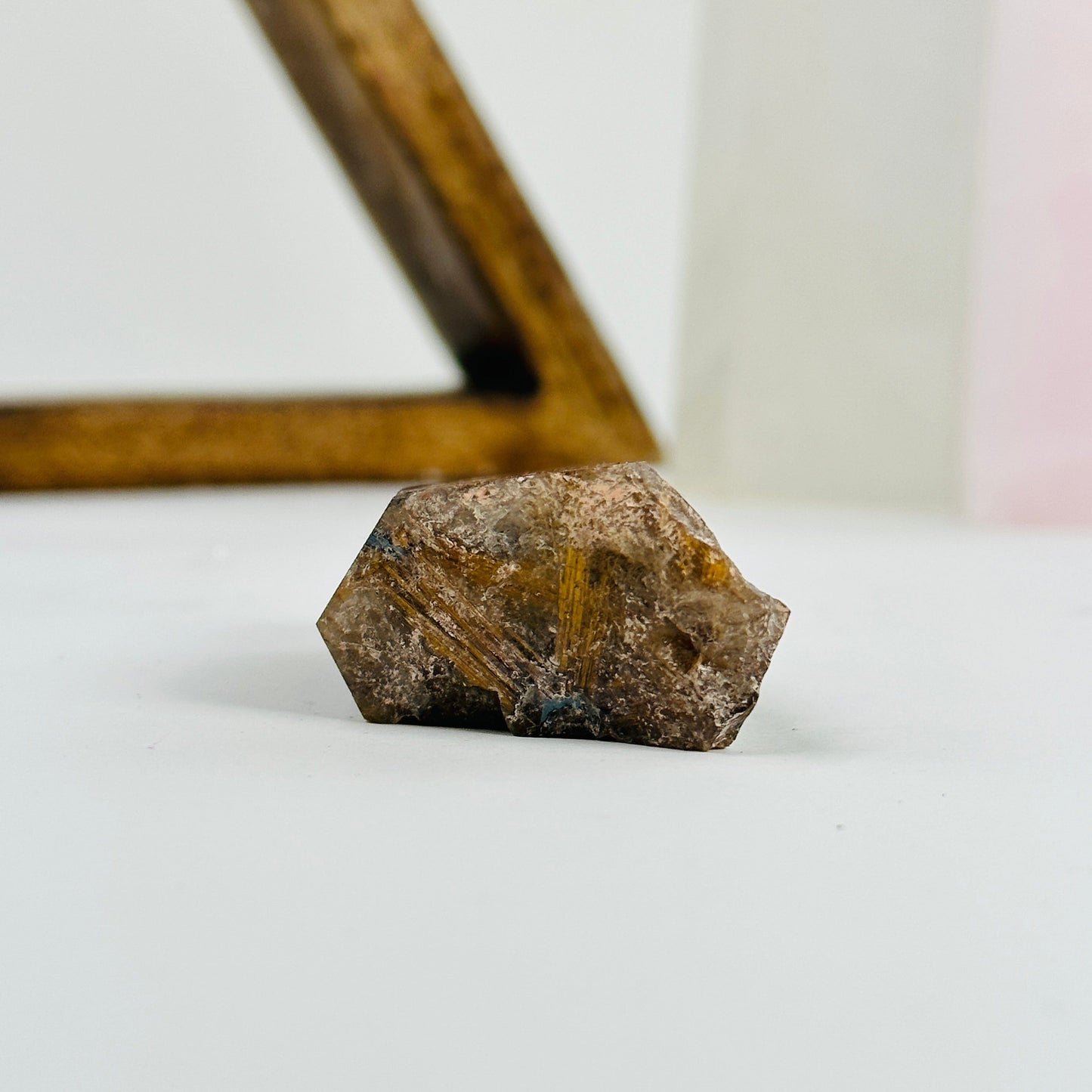 rutilated quartz with decorations in the background
