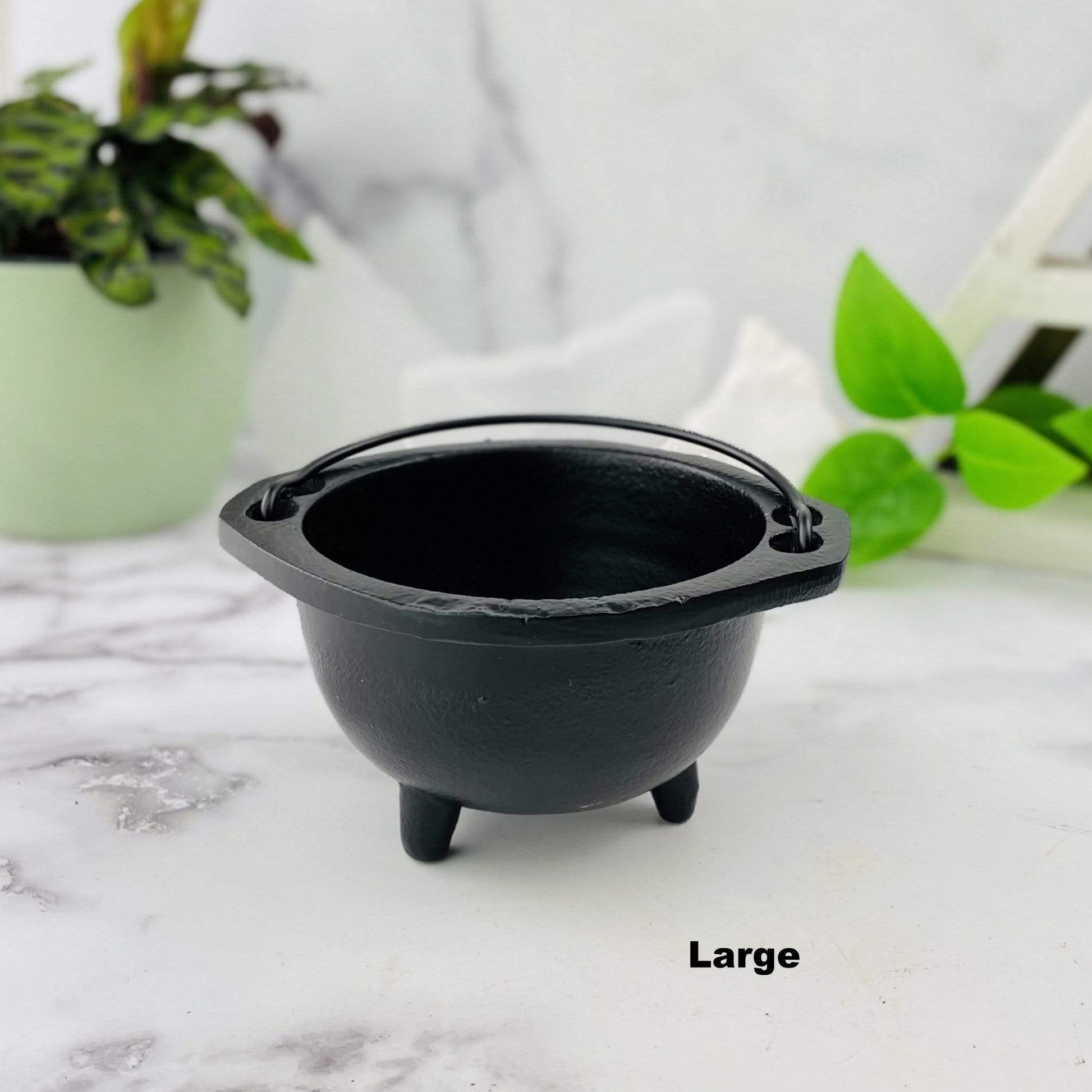 A large Black Cauldron with handles 