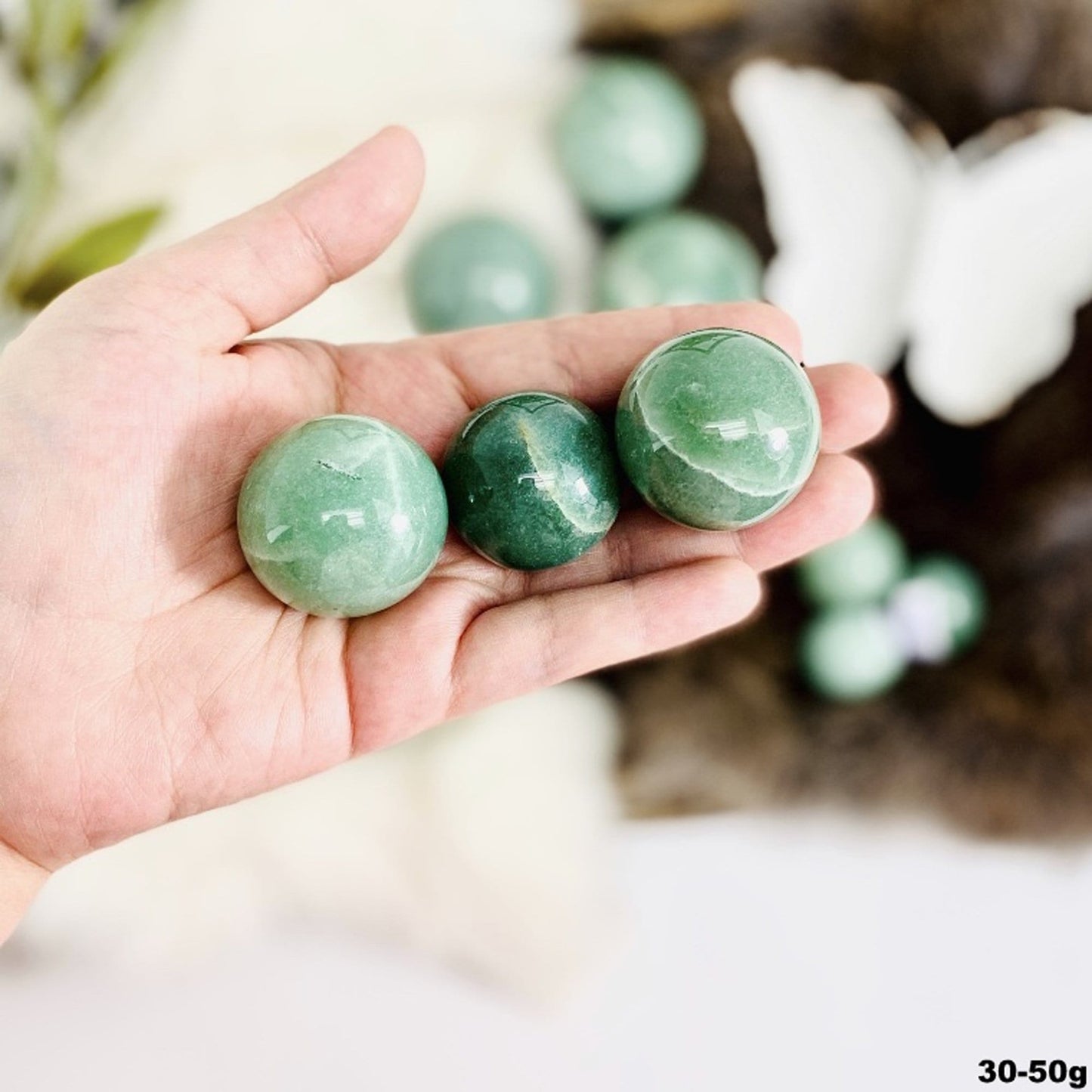 spheres in hand for size reference. showing the 30-50g size