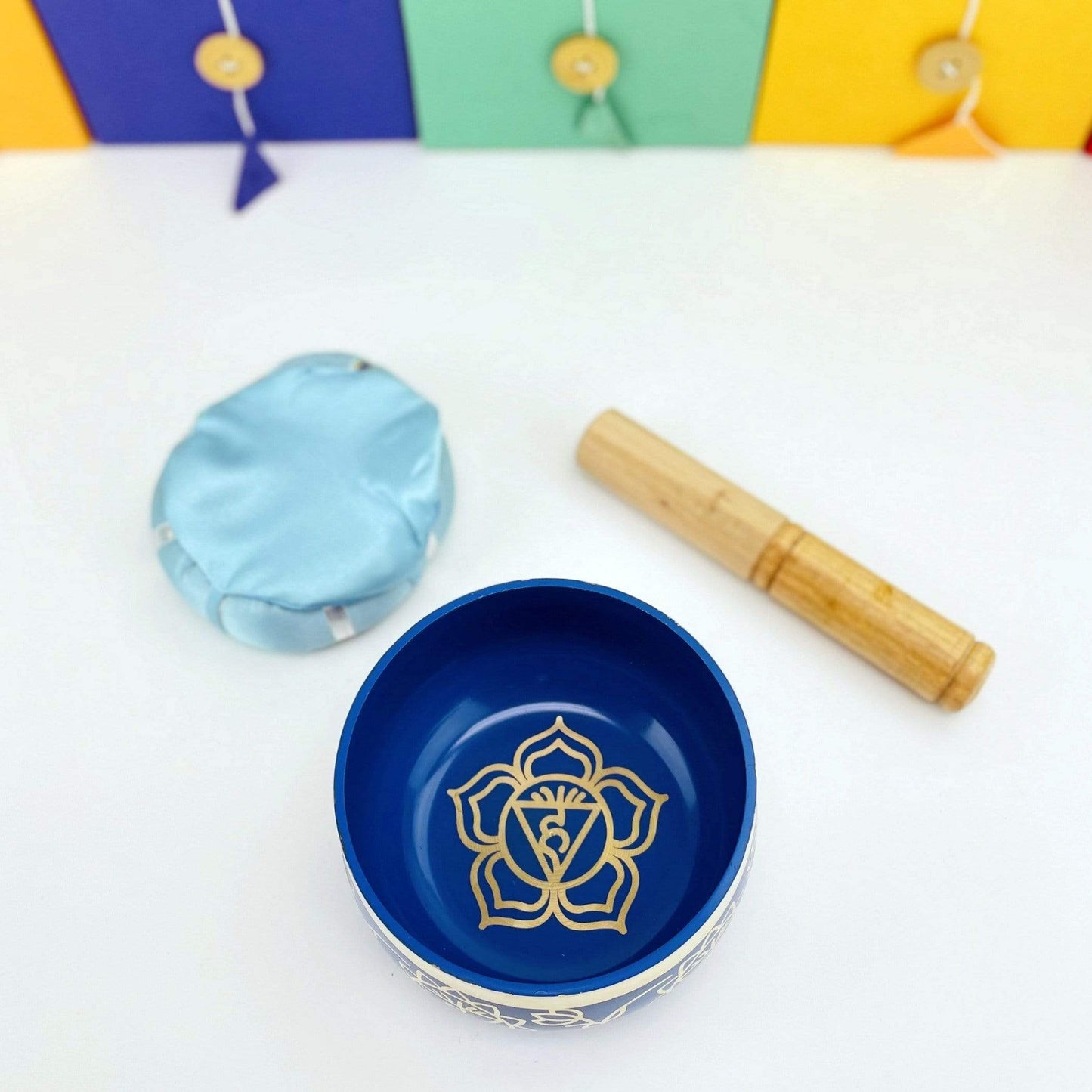 Brass Tibetan Third eye Chakra Singing Bowl next to the pillow and mallot
