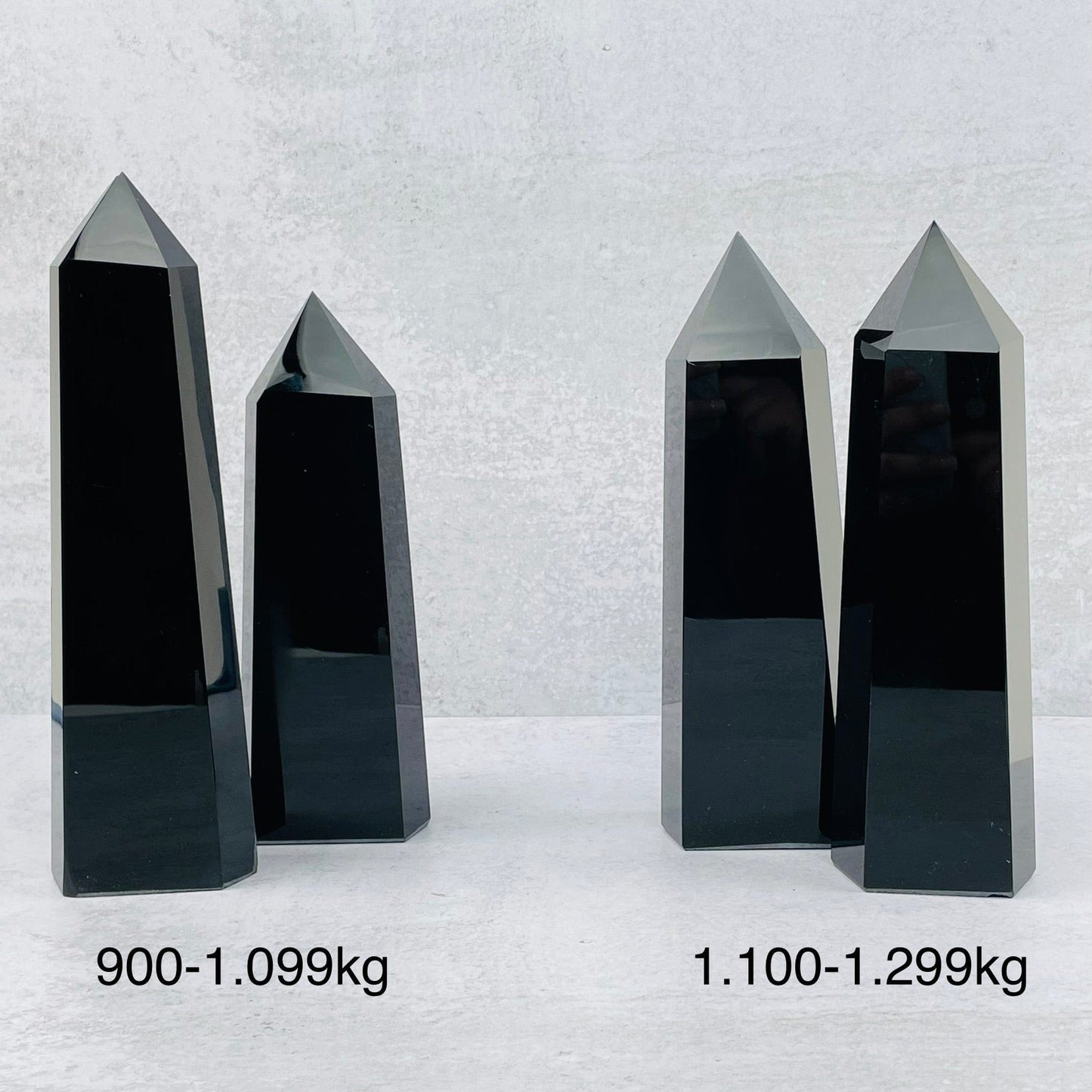 black obsidian towers next to their sizes 