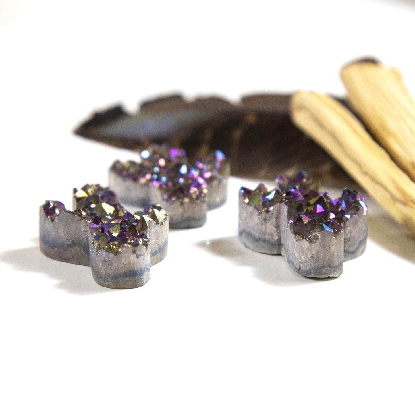 side view of titanium druzy cactus with decorations in the background