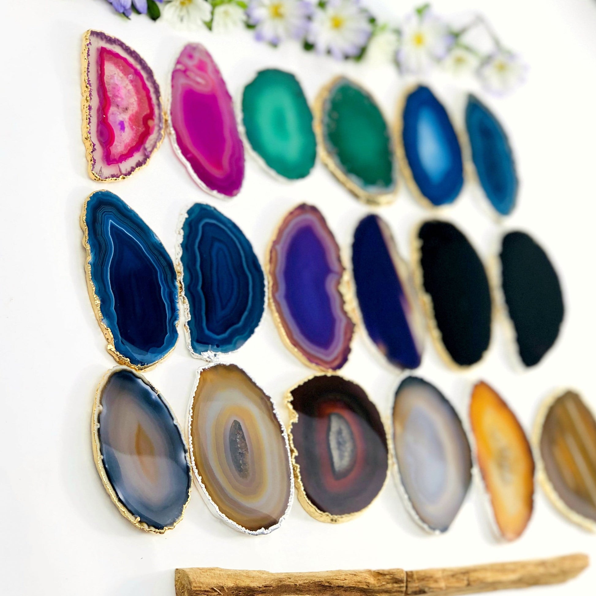 This picture is showing all the variety of colors we have available for our agate slices plated edge, on a white background.