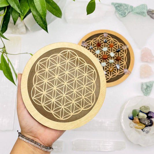 wooden flower of life grid in a hand