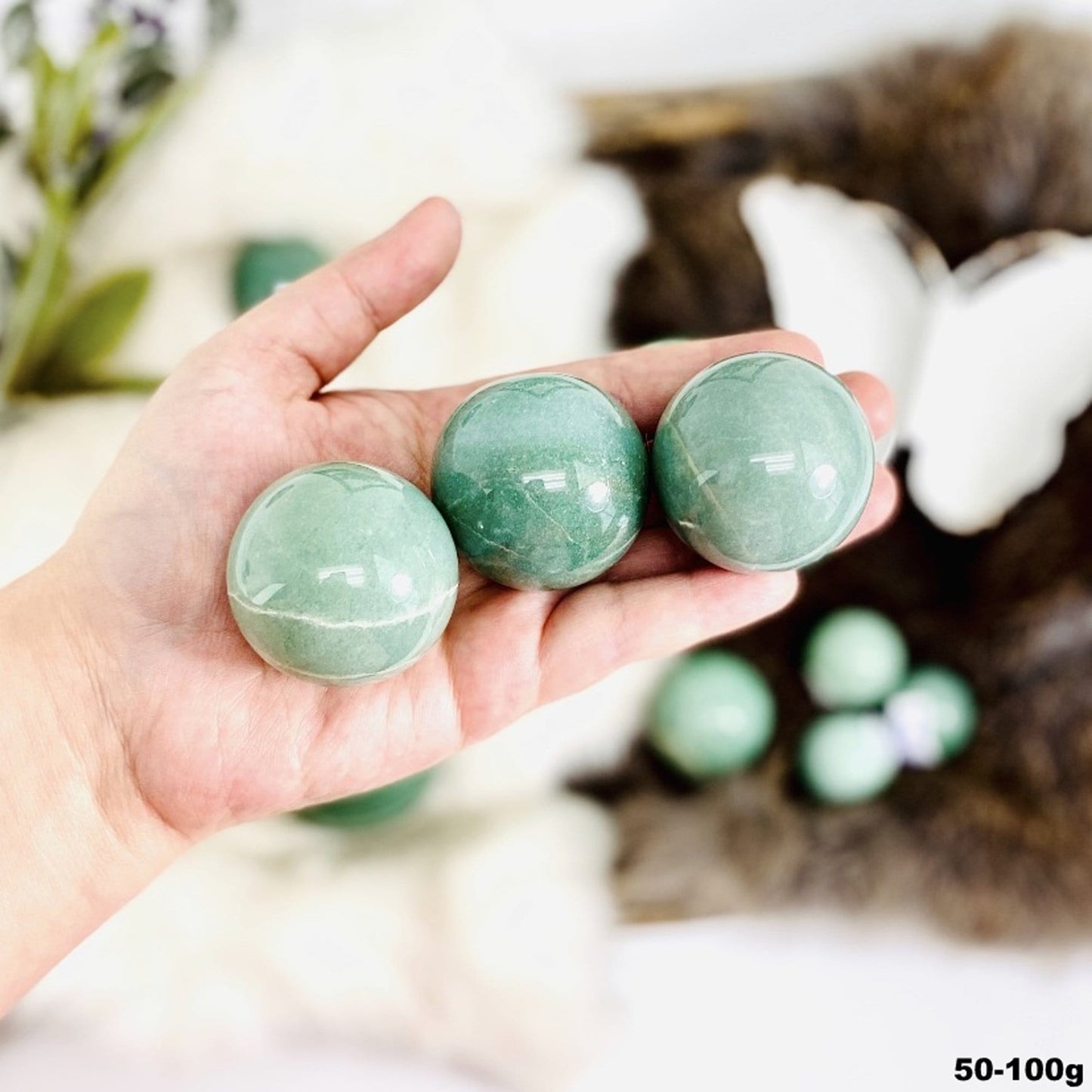 spheres in hand for size reference. showing the 50-100g size