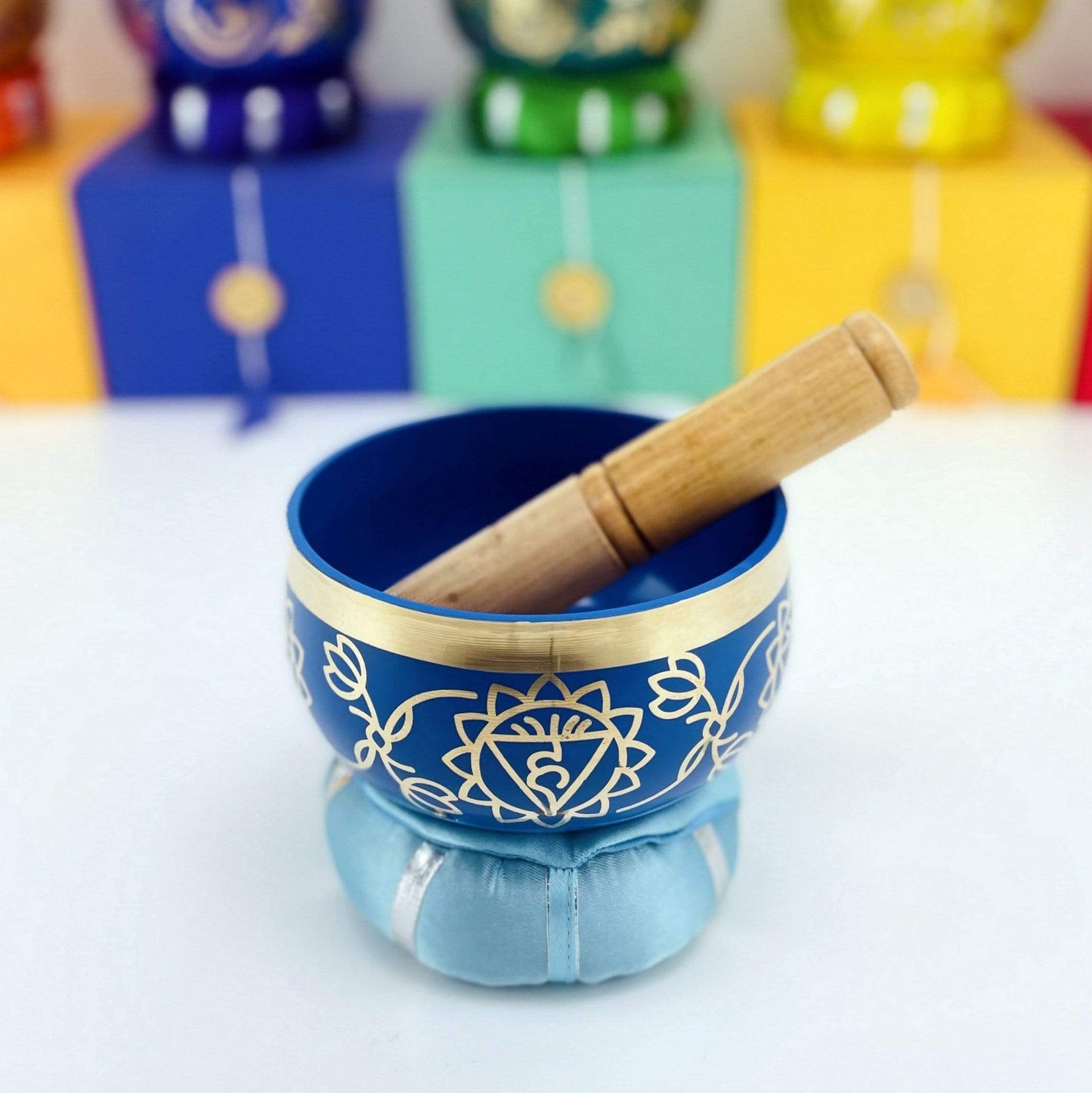Brass Tibetan third eye Chakra Singing Bowl on top of the pillow with a mallot inside