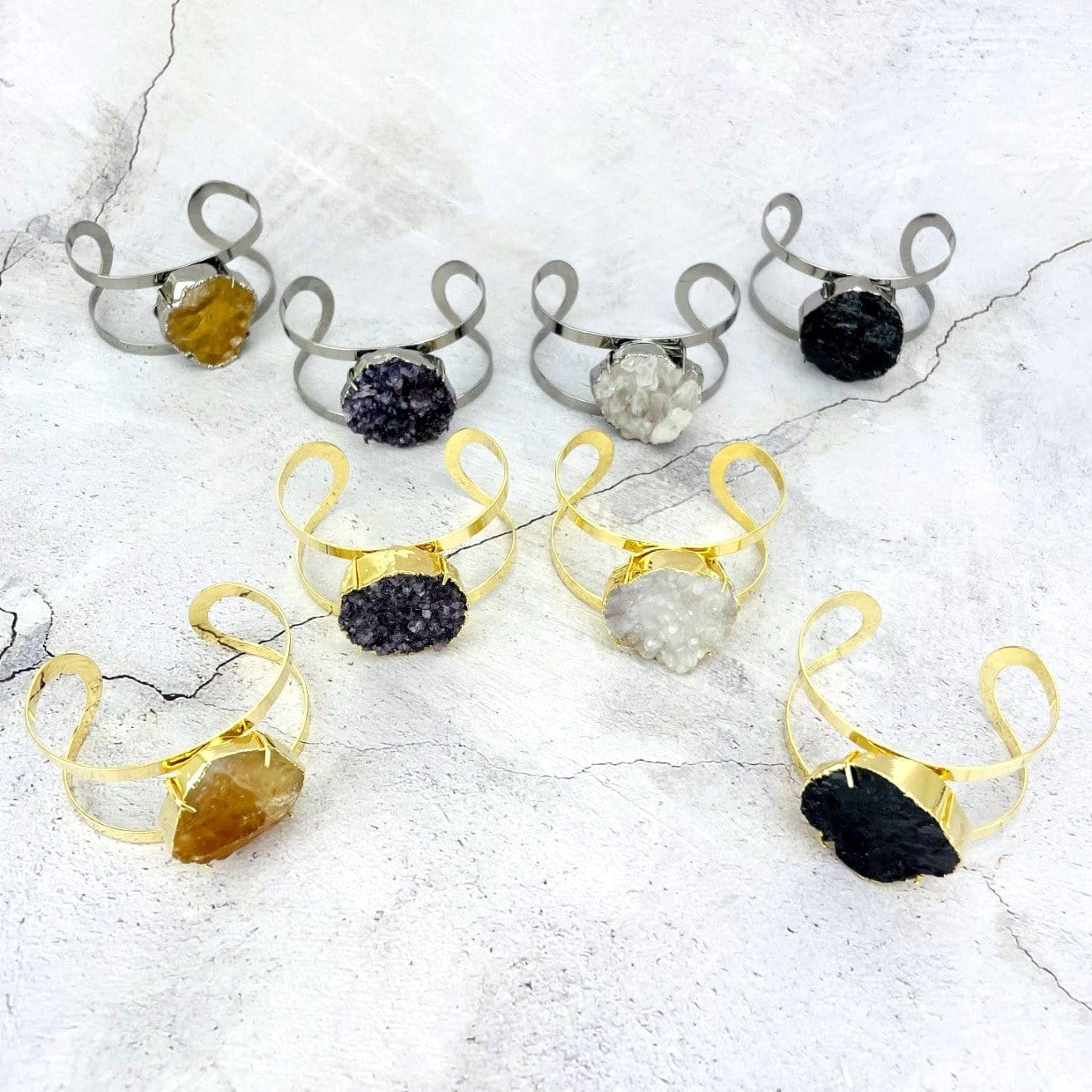 8 stone  bracelets spread out on a table
