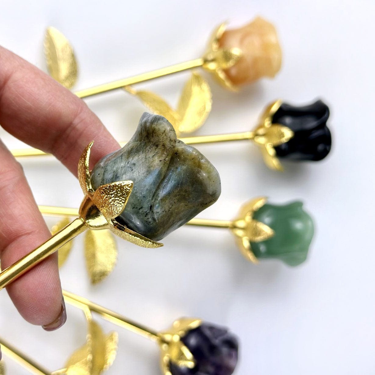 Up close of the labradorite carved rose with others in background