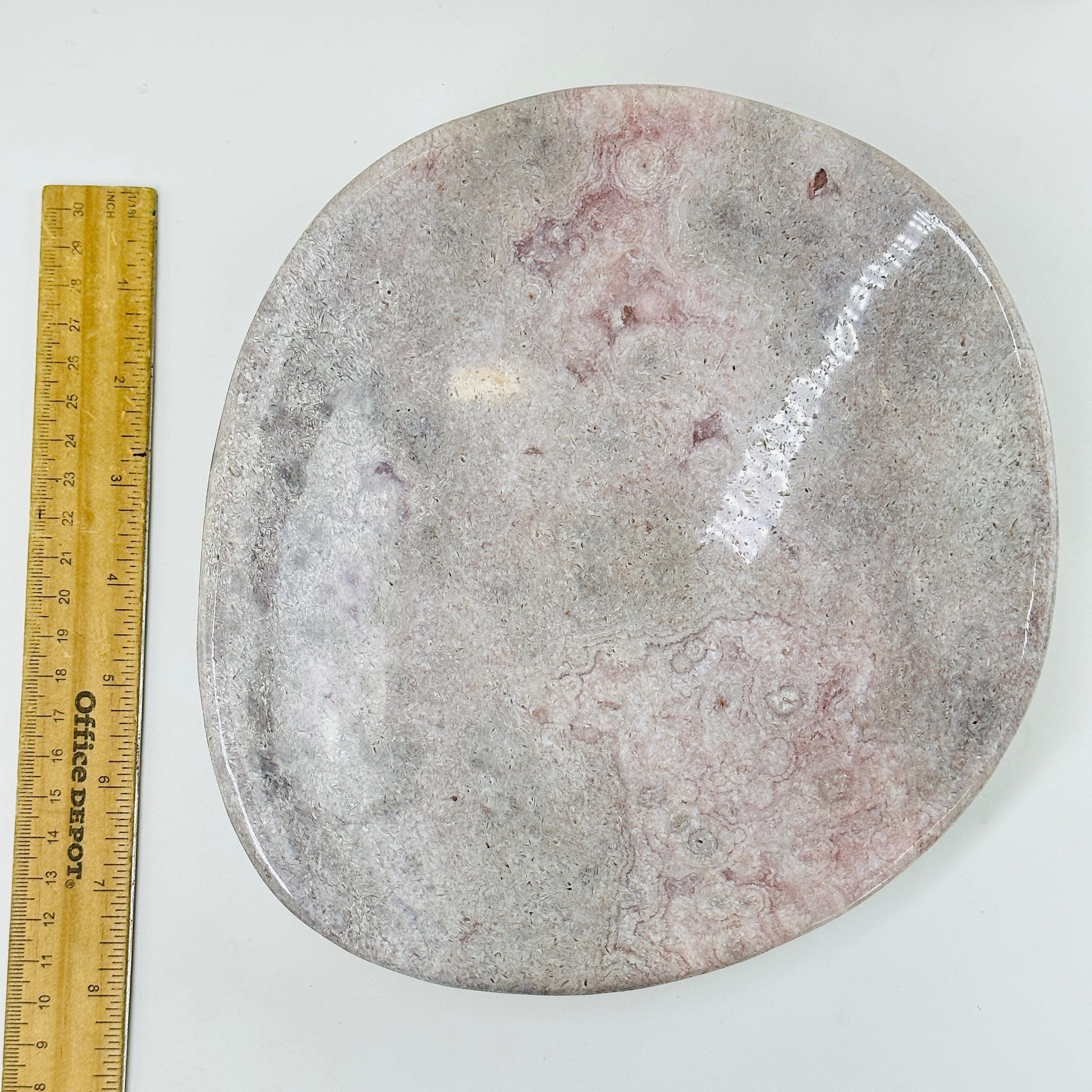 pink amethyst plate next to a ruler for size reference