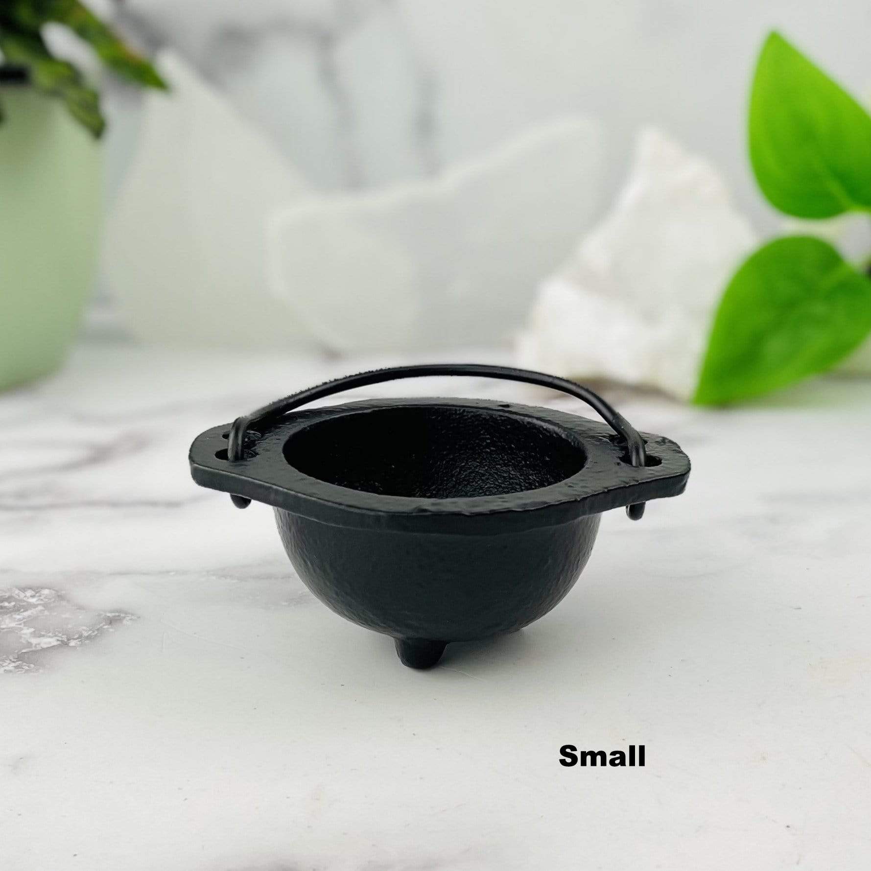 Small black iron cauldron.