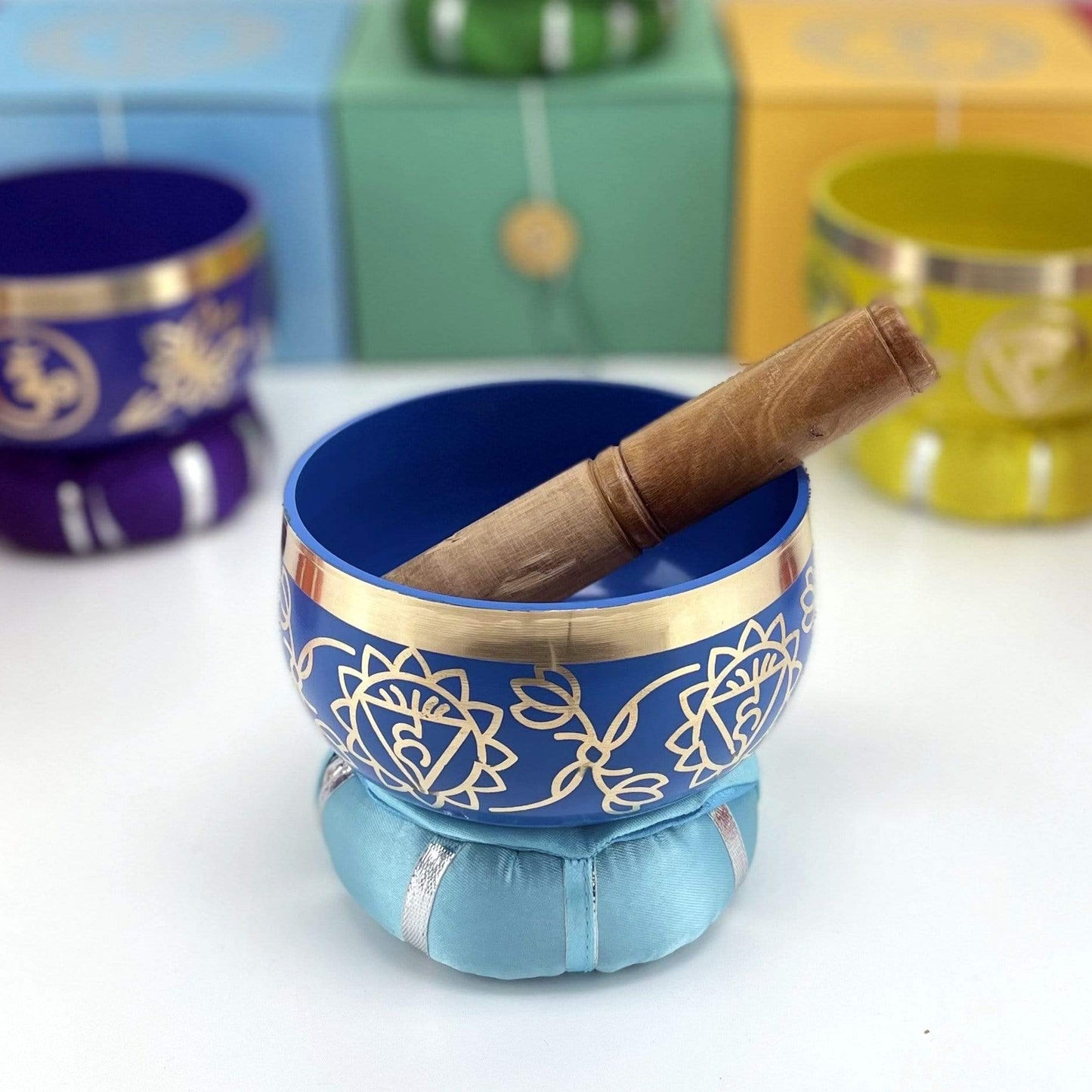 Brass Tibetan third eye Chakra Singing Bowl on top of pillow with mallot inside