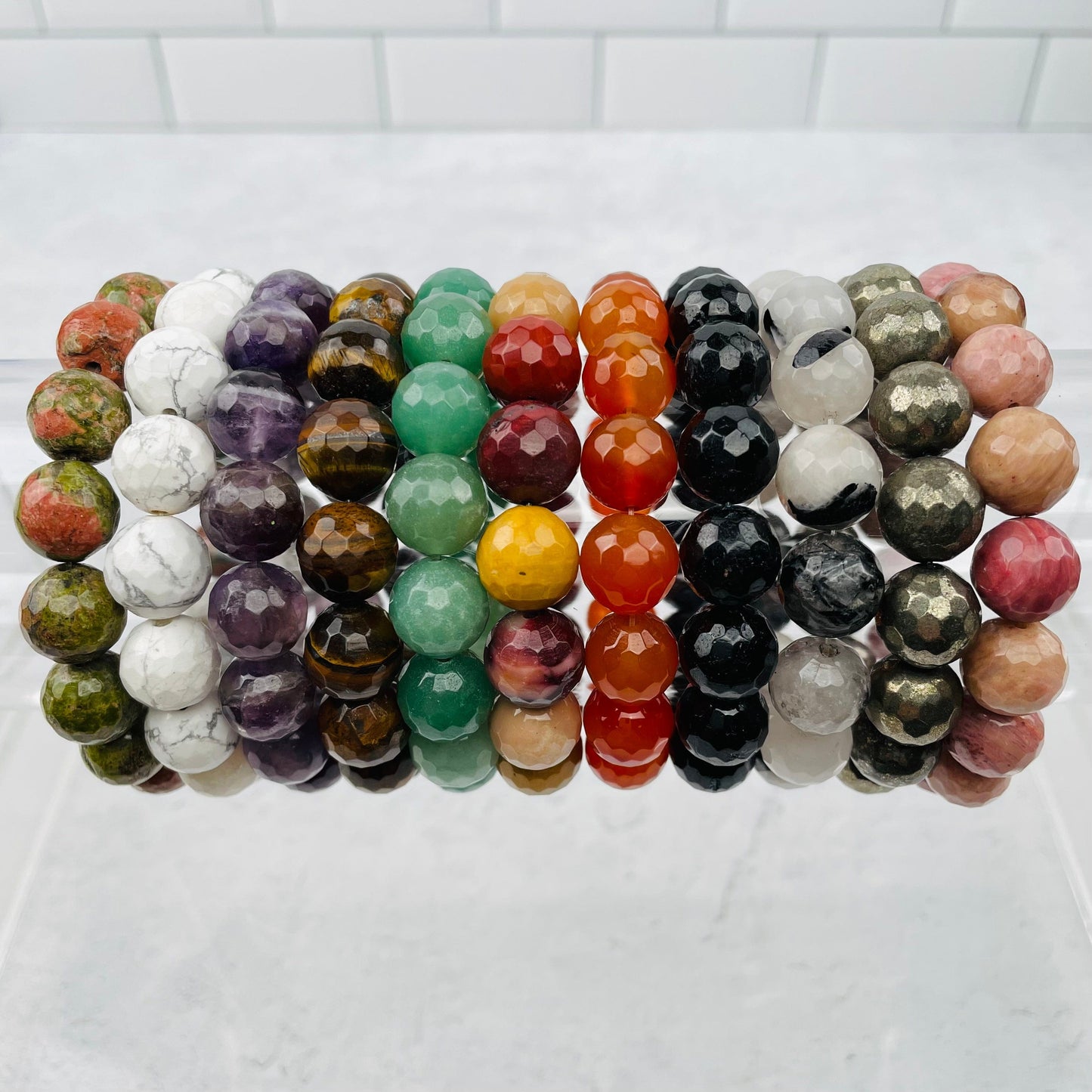 Round Bead Faceted Bracelets - 12mm - displayed next to each other to show the differences in the crystal types 