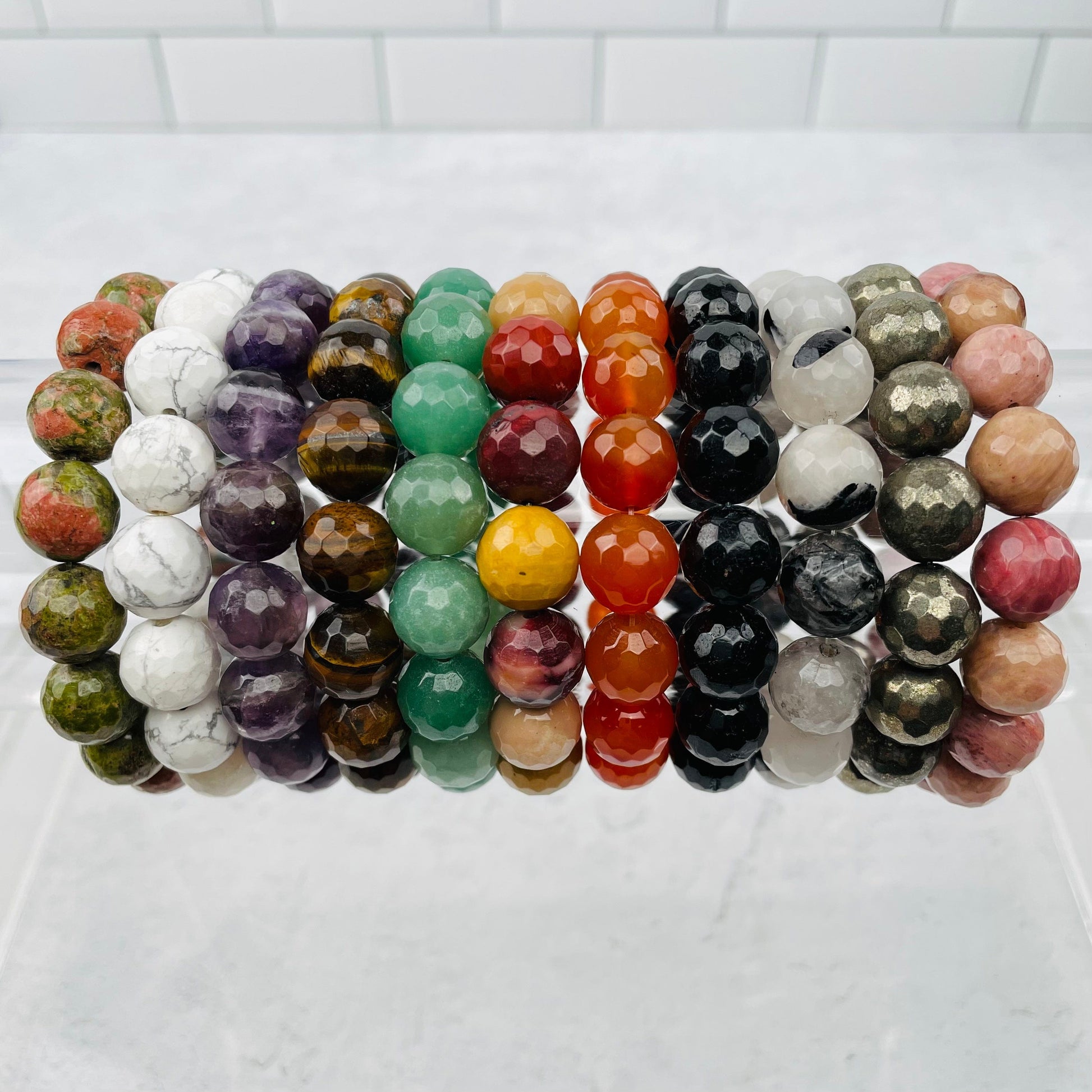 Round Bead Faceted Bracelets - 12mm - displayed next to each other to show the differences in the crystal types 