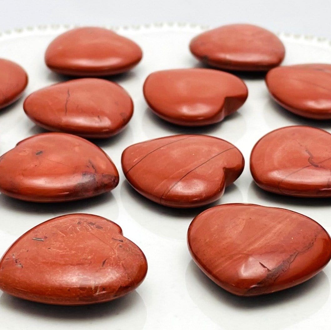 Side view of Red Jasper Heart Shaped Stones on white background