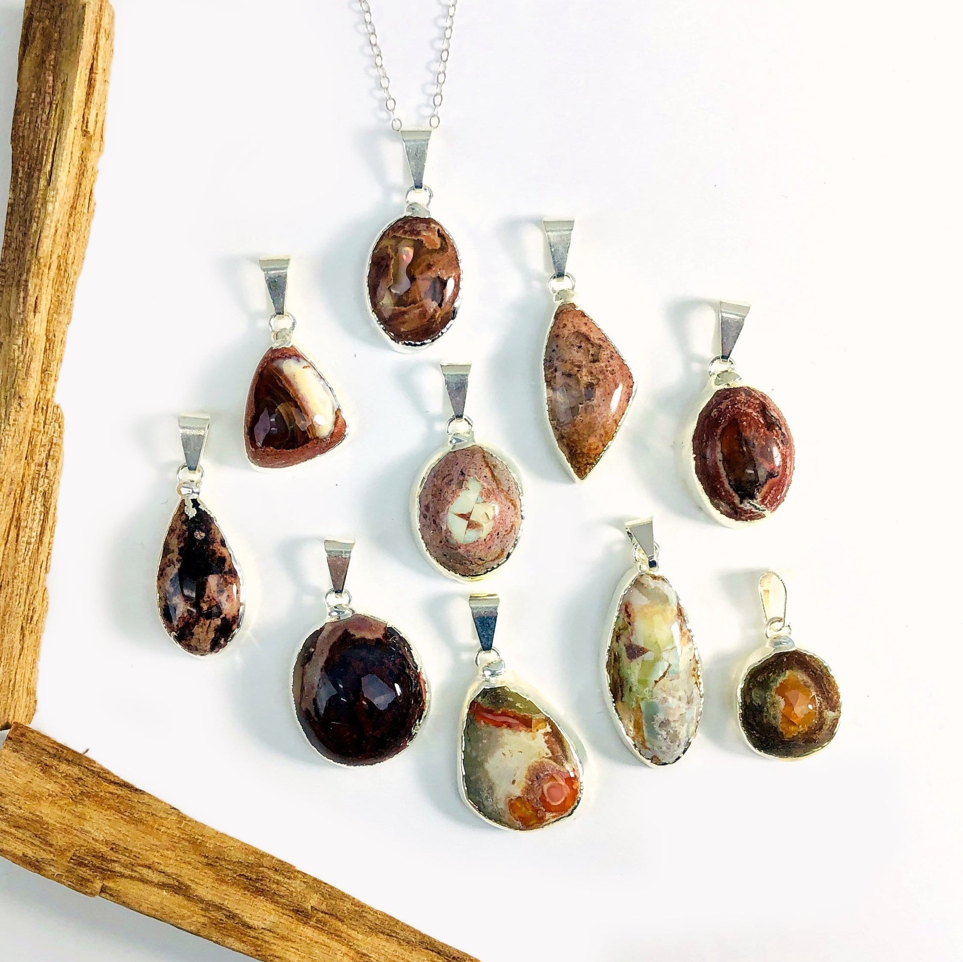 Mexican opal pendants in silver on white background