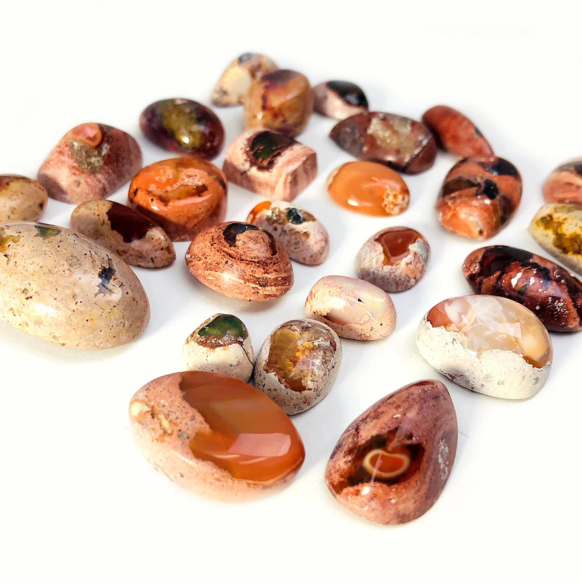 Opal Cabochons Mexican Fire Opal - several on a table, close up
